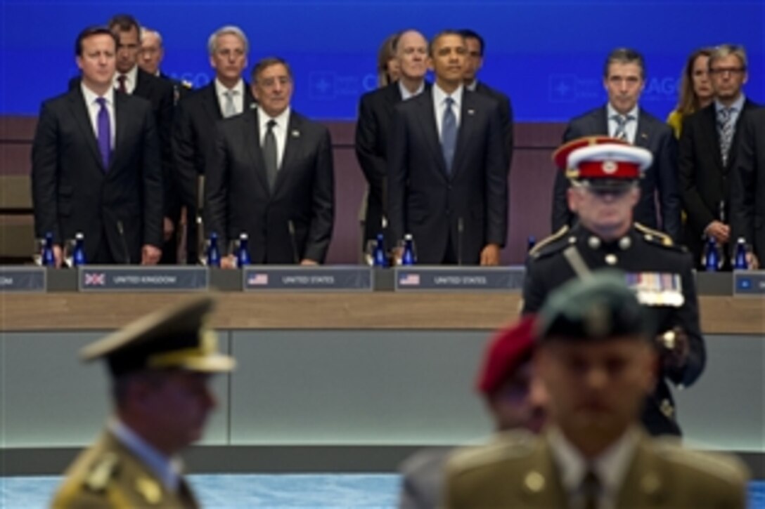 British Prime Minister David Cameron, U.S. Defense Secretary Leon E. Panetta, U.S. President Barack Obama and NATO Secretary General Anders Fogh Rasmussen observe a NATO color guard before a moment of silence honoring service members killed or wounded in Afghanistan at the NATO summit in Chicago, May 20, 2012. 