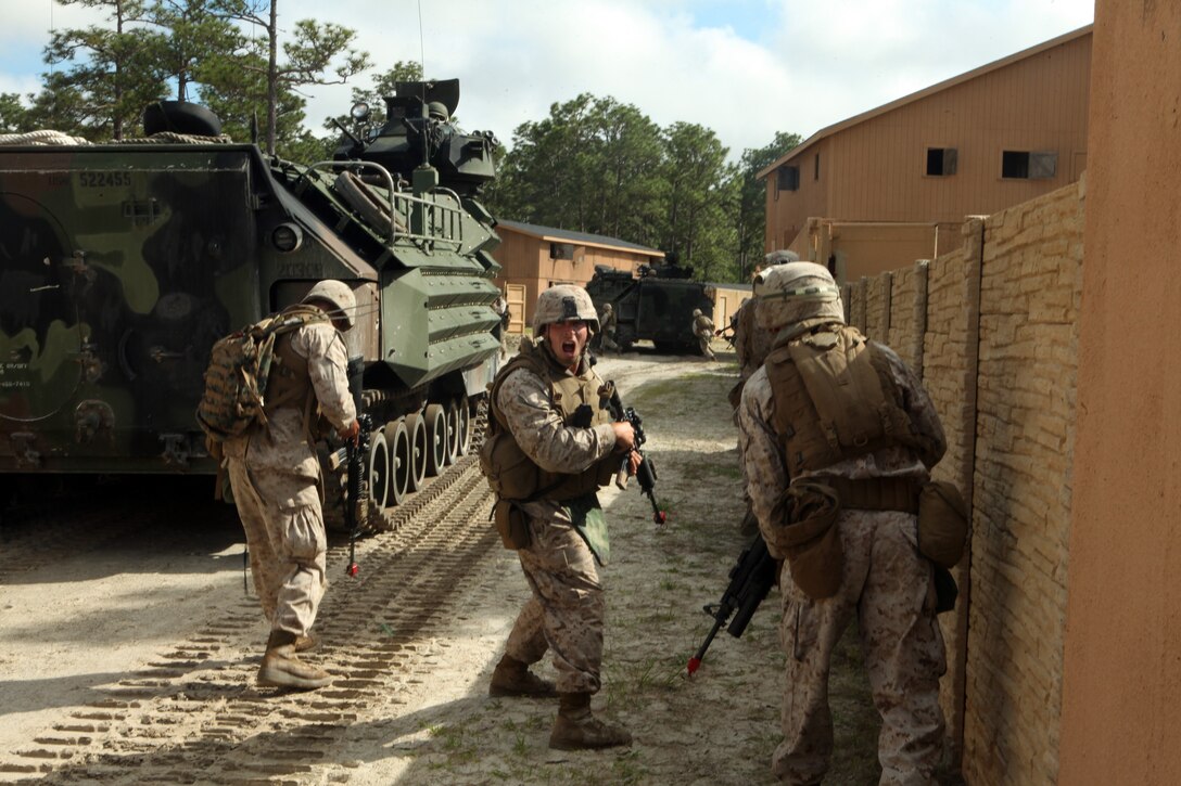 Sergeant Dolphus Hill, billeting chief, police sergeant, and color sergeant with I Marine Expeditionary Force Headquarters Group (Forward), hits golf balls to practice his swing at Camp Leatherneck, Afghanistan, May 21.