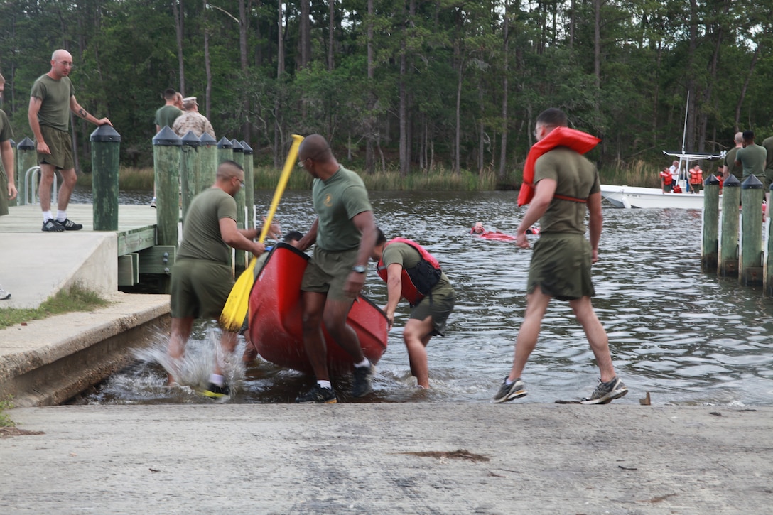 Marines with Marine Attack Squadron 231 compete in the "Feats of Strength" competition, May 21, at Hancock Lodge aboard Marine Corps Air Station Cherry Point. The Marines conducted a relay foot race carring canoes which they eventually had to race to the docks and through the finish line.