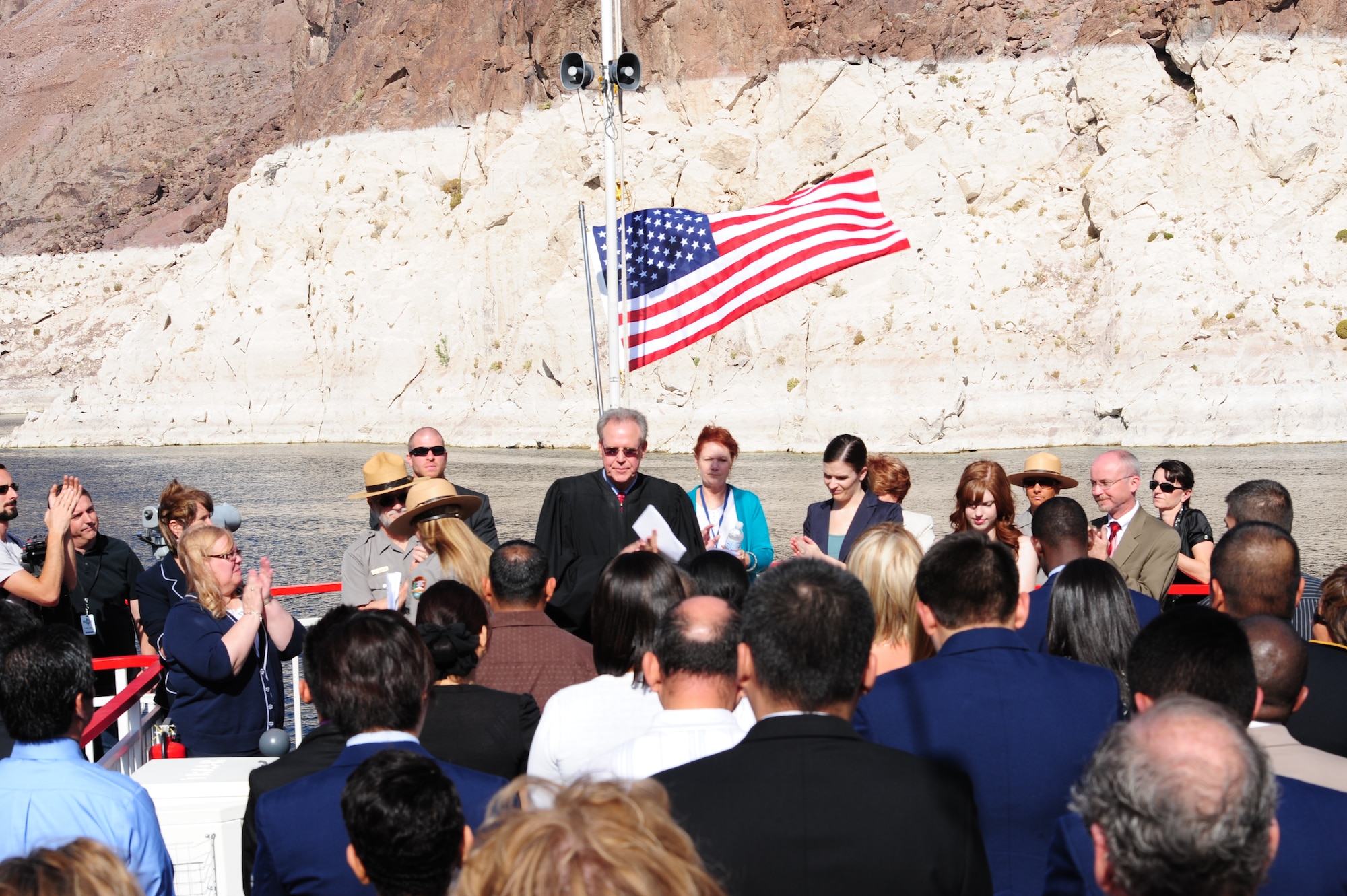 United States District Judge for the District of Nevada, the Honorable Judge George Foley, administers the Oath of Allegiance to 24 newly naturalized U.S. citizens May 18, 2012, at Lake Mead, Nev. Representatives of 12 different countries and five Airmen from Nellis Air Force Base participated in the Naturalization Ceremony. (U.S. Air Force photo by Airman 1st Class Christopher Tam)