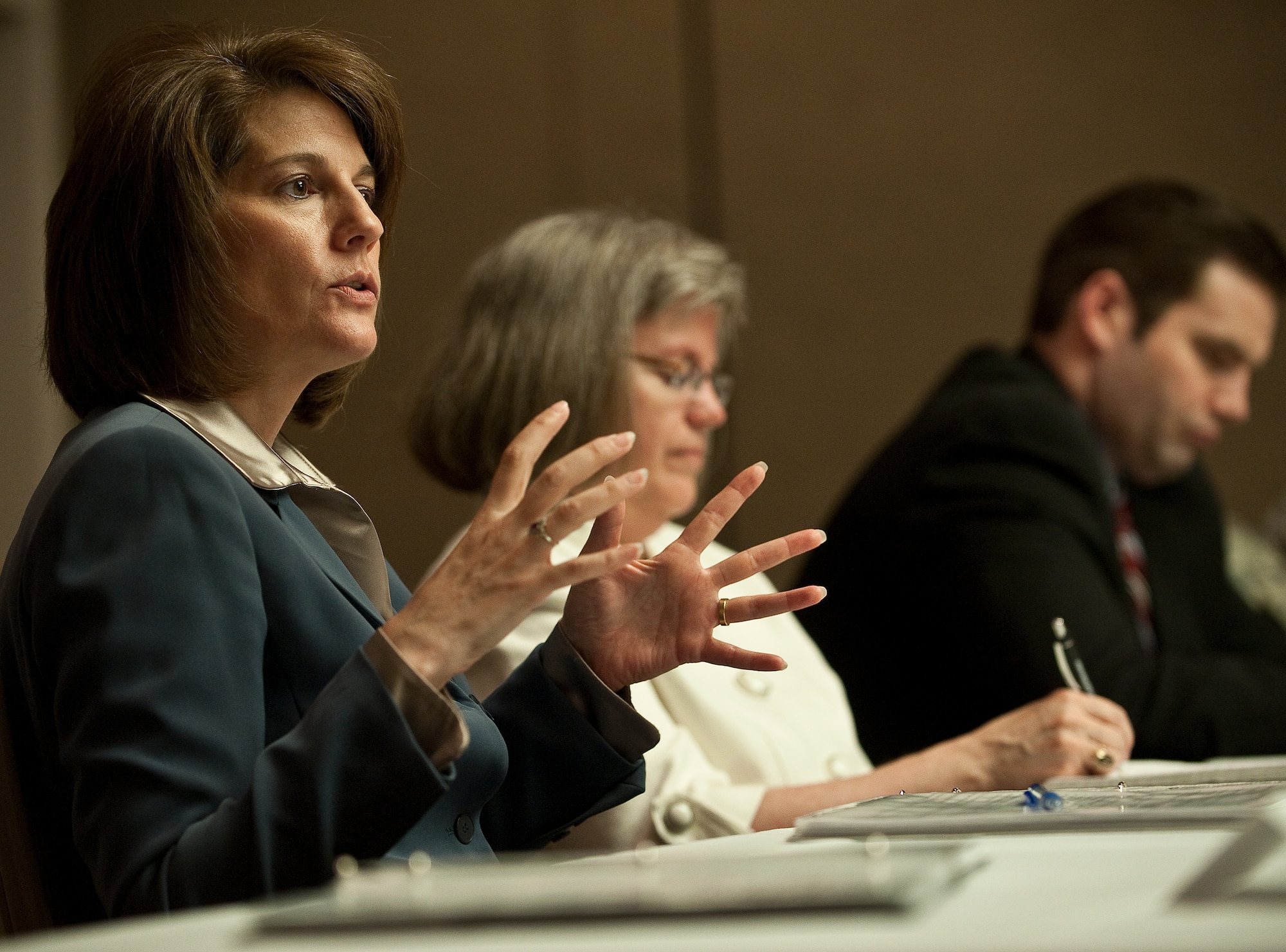 Catherine Cortez Masto (left), Nevada attorney general, and Holly Petraeus (center), Consumer Financial Protection Bureau servicemember affairs director, brief first sergeants on ways to defend Airmen against financial scams during a town hall meeting May 16, 2012, at Nellis Air Force Base, Nev. Masto and Petraeus spoke with Airmen and base senior leaders about ways to avoid consumer financial scams. (U.S. Air Force photo by Staff Sgt. Christopher Hubenthal)