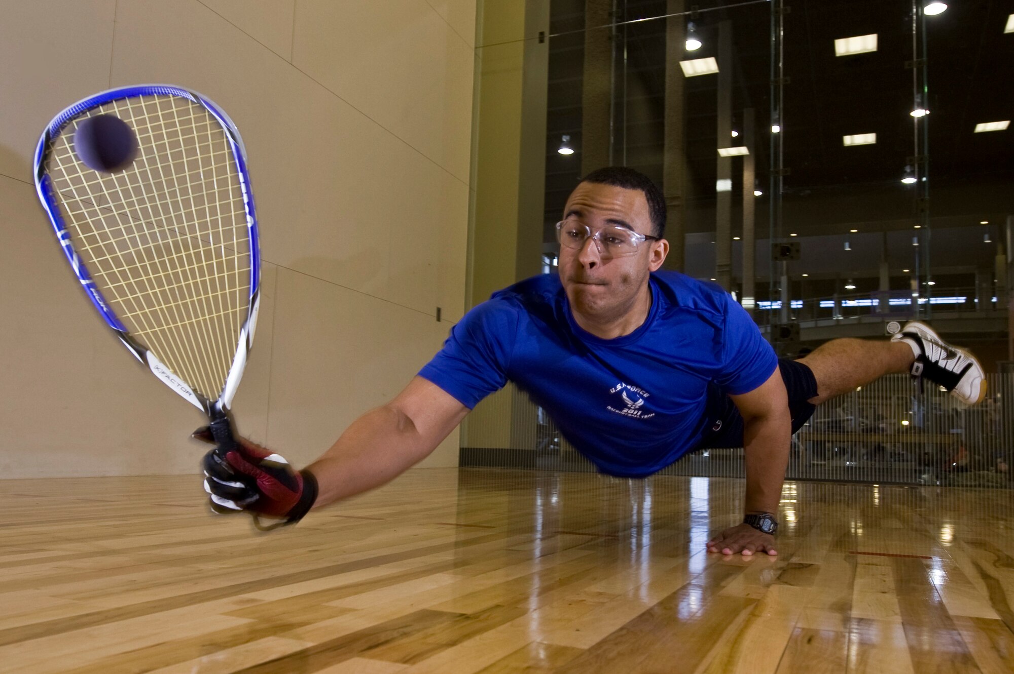 U.S. Air Force 2nd Lt. Maurice Mckoy, 99th Comptroller Squadron financial officer, dives to hit the raquetball May 17, 2012, at Nellis Air Force Base, Nev. McKoy has been playing competitive racquet ball for more than 12 years and was hand-picked by the chief of Air Force sports to represent the Air Force in the 45th National Racquetball Singles Championship in Fullerton, CA. (U.S. Air Force photo by Airman 1st Class Daniel Hughes)

