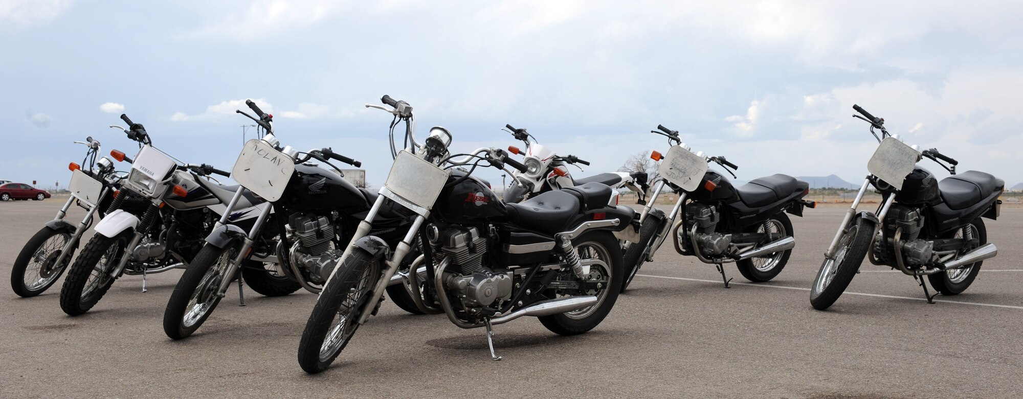 Motorcycles rest on the Motorcycle Safety Basic Rider Course training pad on Davis-Monthan Air Force Base, Ariz., May 9, 2012. The motorcycles are provided by the training course to students to practice the basic riding techniques. Some more advanced riding courses require students to supply their on motorcycles. (U.S. Air Force photo by Airman 1st Class Timothy D. Moore/Released)
