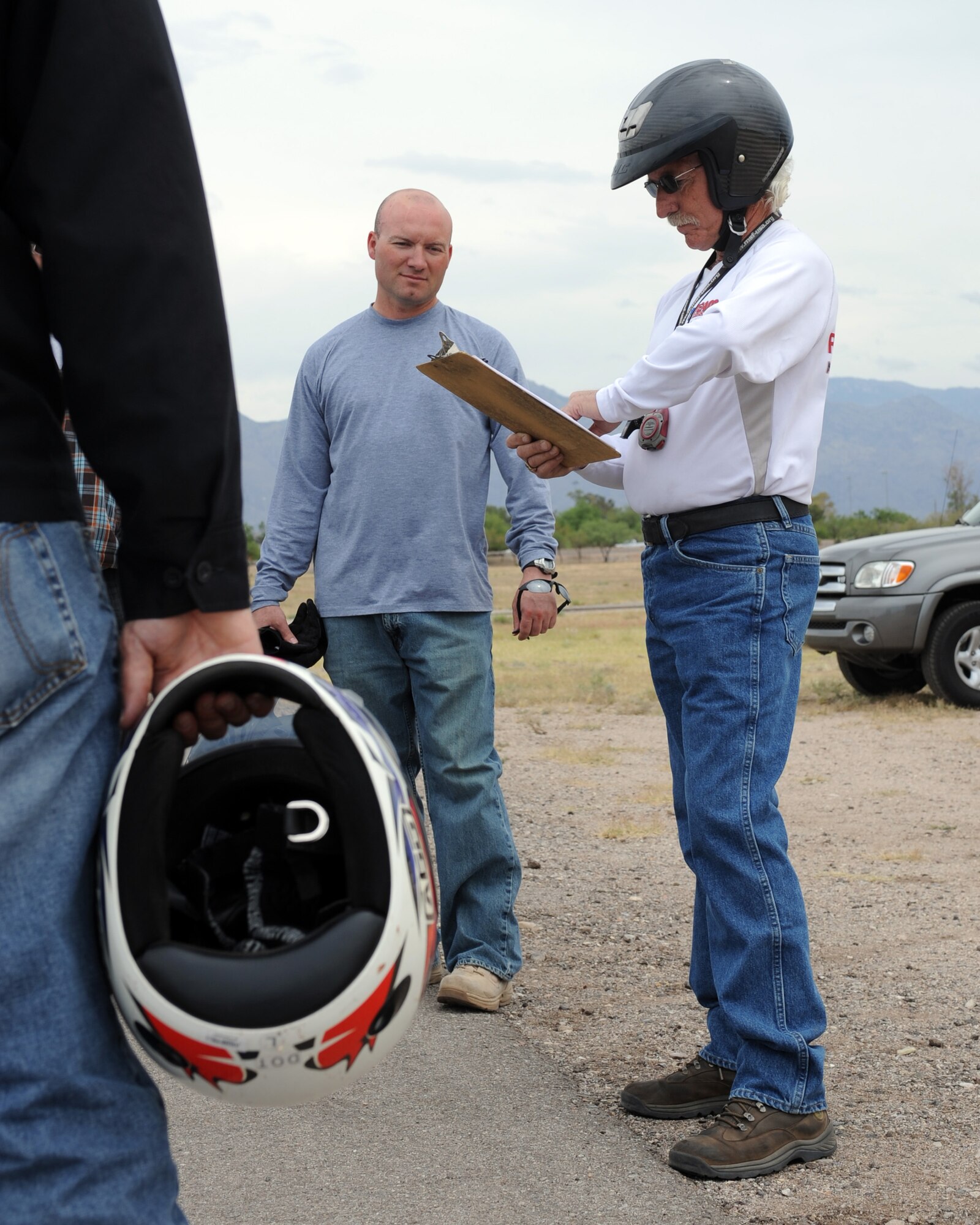 Chris Life, motorcycle safety instructor, reads the final evaluation scores to Master Sgt. Tracey Booth, 355th Security Forces Squadron, and the other students of the Motorcycle Safety Basic Rider Course on Davis-Monthan Air Force Base, Ariz., May 9, 2012. The final evaluation tested the students’ abilities to perform the basic riding techniques taught in the course. (U.S. Air Force photo by Airman 1st Class Timothy D. Moore/Released)