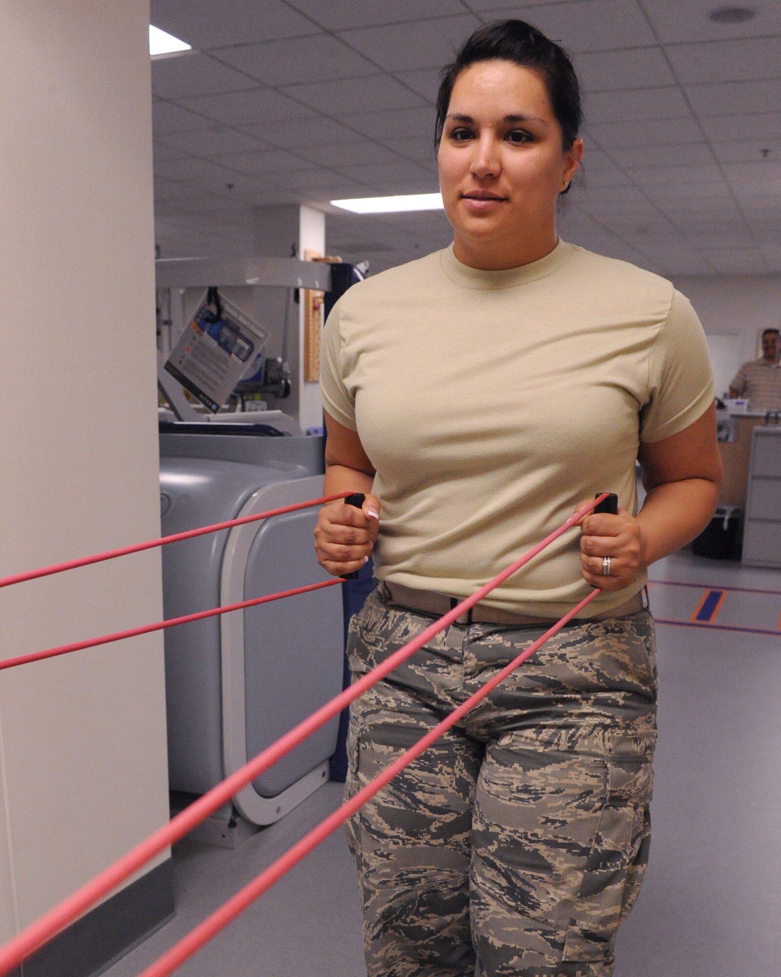 U.S. Air Force Master Sgt. Livia Almandos, 162nd Fighter Wing, works on her arms with an resistance bands at the Physical Therapy Clinic on Davis-Monthan Air Force Base, Ariz., May 16, 2012. Resistance bands provide more of a range of motion when training. (U.S. Air Force photo by Airman 1st Class Christine Griffiths/Released) 