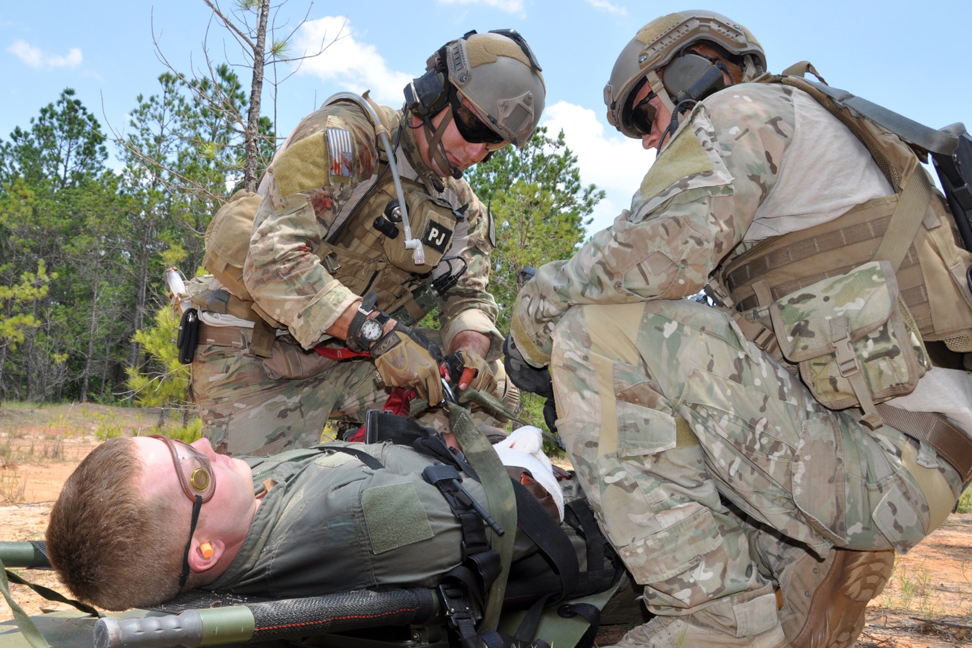 Pararescuemen assigned to the 920th Rescue Wing from Patrick Air Force Base, Fla., prepare an injured patient for hoisting into a medical helicopter during the mass casualty phase of the Patriot Saint exercise at Fort Polk, La., May 17, 2012. The goal of the exercise was to challenge pararescuemen to successfully execute combat search and rescue (CSAR) missions in real time while tactically solving enroute, fuel, communication, and OPFOR (Opposing Force) hurdles. (U.S. Air Force photo by Master Sgt. Jeff Walston/Released)