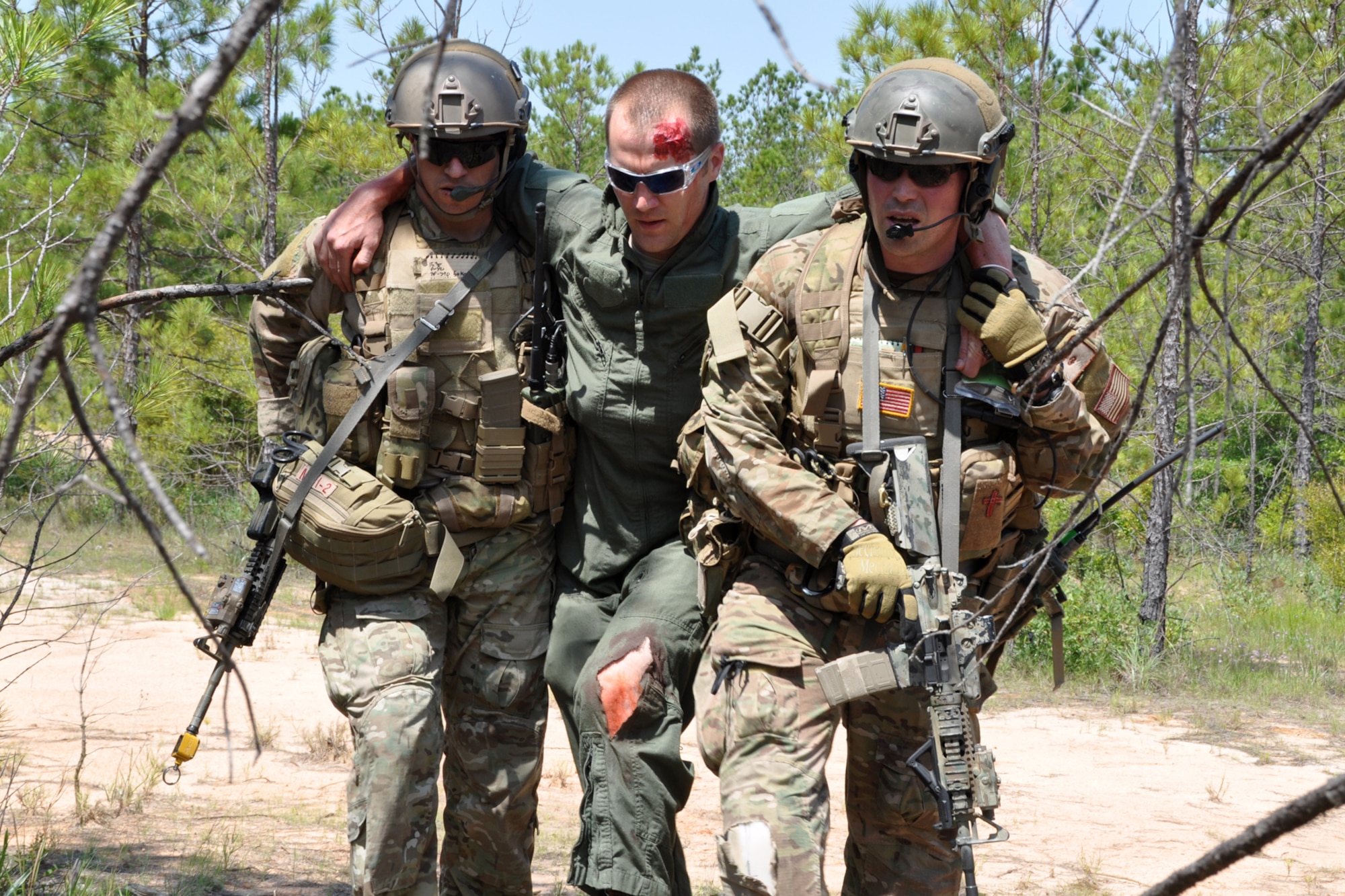 Parareascuemen from the 920th Rescue Wing at Patrick Air Force Base, Fla., assist a crewman of a downed C-130 during the mass casualty phase of the Patriot Saint exercise at Fort Polk, La., May 17, 2012. The goal of the exercise was to challenge pararescuemen to successfully execute combat search and rescue (CSAR) missions in real time while tactically solving enroute, fuel, communication, and OPFOR (Opposing Force) hurdles. (U.S. Air Force photo by Master Sgt. Jeff Walston/Released)
