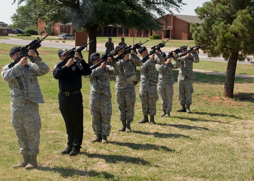 A seven-man firing party perform a 21-gun-salute during a retreat ceremony May 18, 2012, at Dyess Air Force Base, Texas. As part of Police Week, a retreat ceremony was held in remembrance of nine members of the squadron who passed away in the line of duty. (U.S. Air Force photo by Airman 1st Class Peter Thompson/ Released)