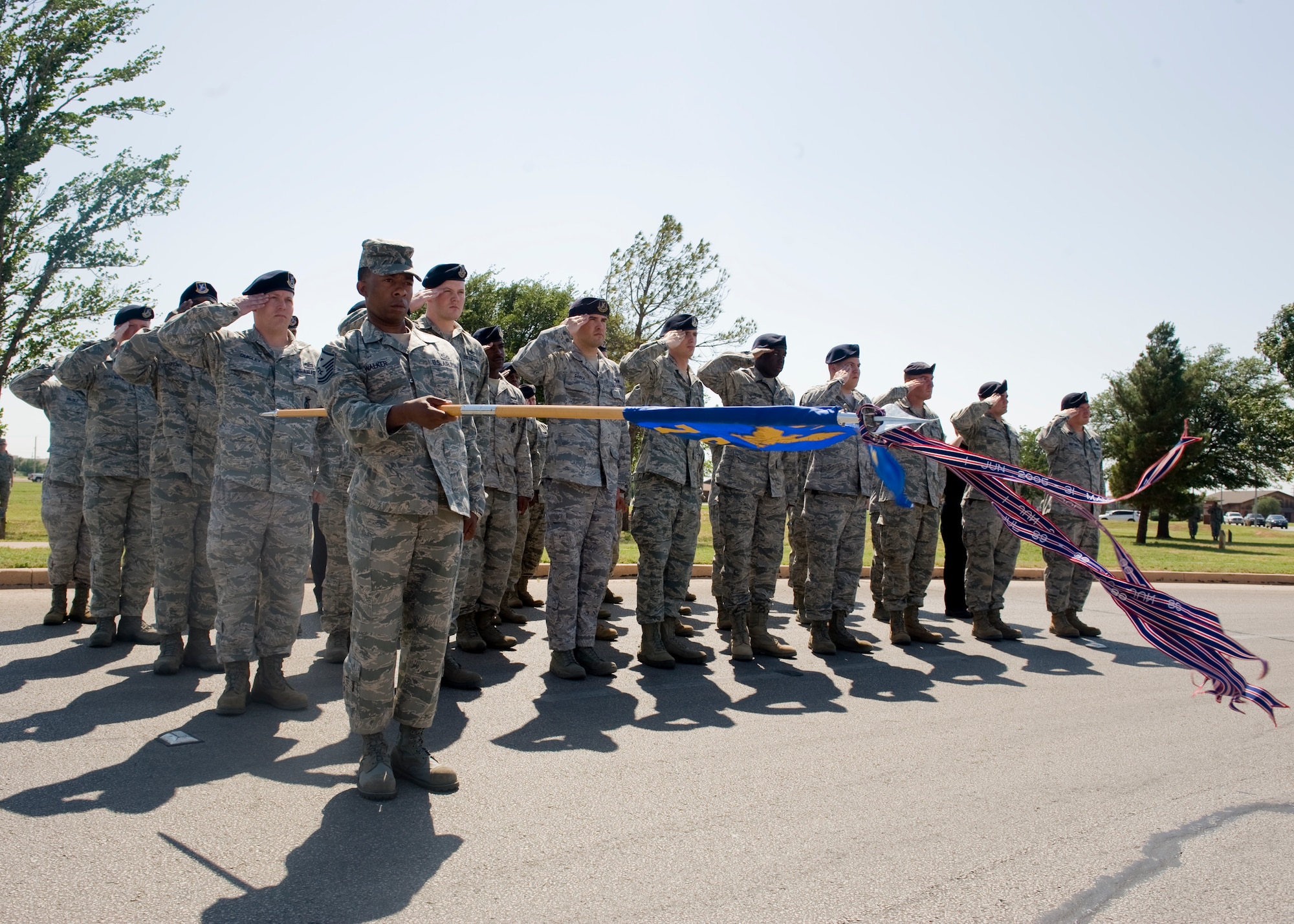 7th Security Forces Squadron airmen render a salute during a retreat ceremony May 18, 2012, at Dyess Air Force Base, Texas. As part of Police Week, a retreat ceremony was held in remembrance of nine members of the squadron who passed away in the line of duty. (U.S. Air Force photo by Airman 1st Class Peter Thompson/ Released)