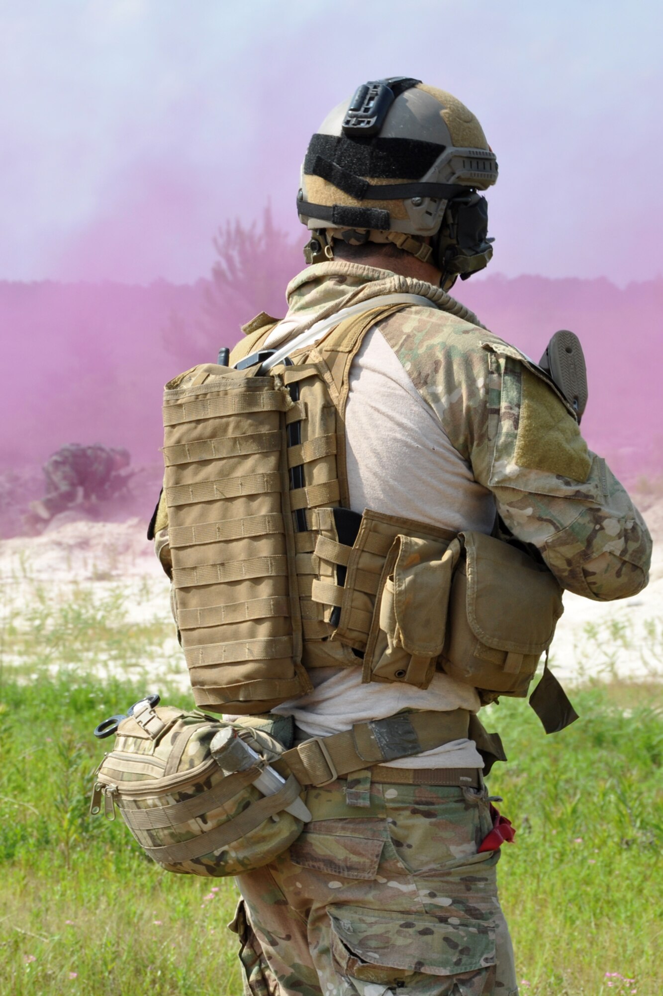 A pararescueman from the 308th Rescue Squadron, Patrick Air Force Base, Fla., pushes back a final attack by OPFOR (Opposing Force) unit members before H-60 helicopters extract them from the field at Fort Polk, La., May 16, 2012. The Airmen were part of a combat search and rescue (CSAR) mission to rescue two downed pilots during the Patriot Saint exercise. (U.S. Air Force photo by Master Sgt. Jeff Walston/Released)