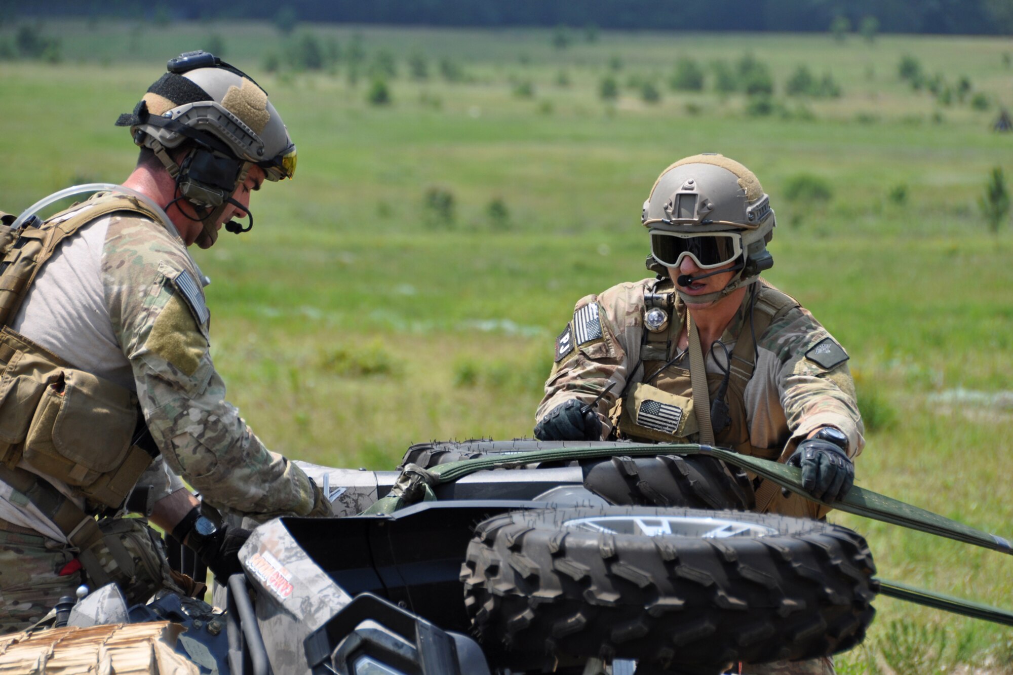 Pararescuemen from the 308th Rescue Squadron, Patrick Air Force Base, Fla., remove an all-terrain vehicle from a pallet after it was dropped out of the back of an HC-130 King, at Fort Polk, La., May 16, 2012. The Airmen were part of a combat search and rescue (CSAR) mission to rescue two downed pilots during the Patriot Saint exercise. (U.S. Air Force photo by Master Sgt. Jeff Walston/Released)