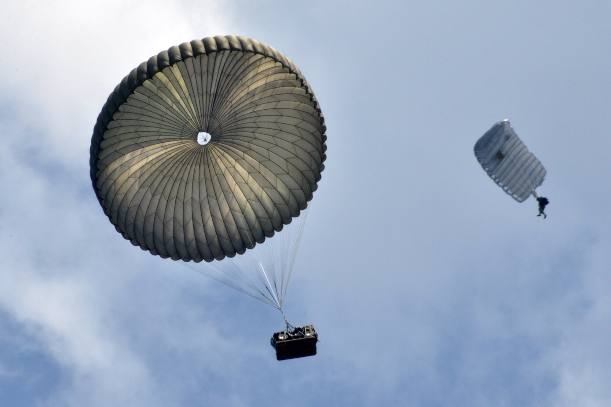 A pararescueman from the 308th Rescue Squadron, Patrick Air Force Base, Fla., follows a pallet with an all-terrain vehicle (quad) strapped to it after it was dropped out of the back of an HC-130 King, at Fort Polk, La., May 16, 2012. Approximately 100 Airmen from numerous units participated in the Patriot Saint exercise, which is designed to hone the war fighting-skills of Air Force pararescuemen for deployment. The exercise also provided A-10 pilots with additional training in executing a search and rescue mission. (U.S. Air Force photo by Master Sgt. Jeff Walston/Released)