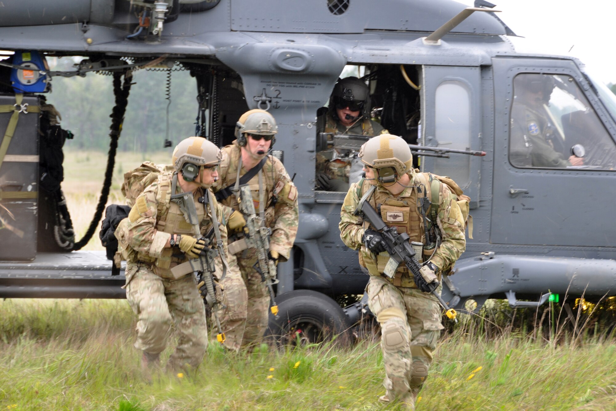 Pararescuemen from the 920th Rescue Wing, Patrick Air Force Base, Fla., disembark from an HH-60 helicopter at landing zone Berry at Fort Polk, La., May 15, 2012. The Airmen were part of a combat search and rescue (CSAR) mission to rescue a soldier from hostile forces in support of the Patriot Saint exercise. (U.S. Air Force photo by Master Sgt. Jeff Walston/Released) 