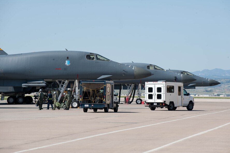 Aircrew from the 37th Bomb Squadron “Tigers” step to the flightline prior to taking off for a Combat Hammer exercise at Ellsworth Air Force Base, S.D., May 14, 2012. Aircrews from both the 34th BS and 37 BS thundered into the Utah Test and Training Range to employ six GBU-54 Laser Joint Direct Attack Munitions as a part of a weapon systems evaluation program to measure the effectiveness of both the munitions and the aircrews. (U.S. Air Force photo by Airman 1st Class Zachary Hada/Released)