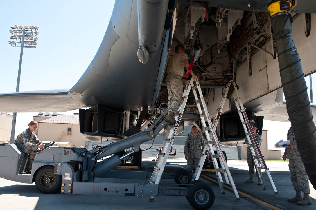 Weapons load crew Airmen assigned to the 28th Aircraft Maintenance Squadron load GBU-54 Laser Joint Direct Attack Munitions into a B-1 bomber for a Combat Hammer exercise at Ellsworth Air Force Base, S.D., May 12, 2012. The LJDAM is a 500-pound, dual-mode guided weapon equipped with a laser seeker, which aids in the ability to engage both stationary and moving targets on the ground. (U.S. Air Force photo by Airman 1st Class Zachary Hada/Released) 