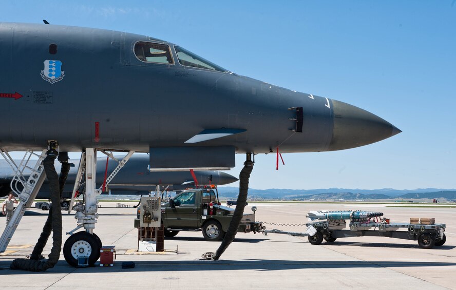 Six GBU-54 Laser Joint Direct Attack Munitions are transported on the flight line in preparation for loading into B-1 bombers for a Combat Hammer exercise at Ellsworth Air Force Base, S.D., May 12, 2012. The goal of the exercise was to evaluate the effectiveness, maintainability, suitability, and accuracy of precision guided munitions and other advanced air to ground weapons. (U.S. Air Force photo by Airman 1st Class Zachary Hada/Released)