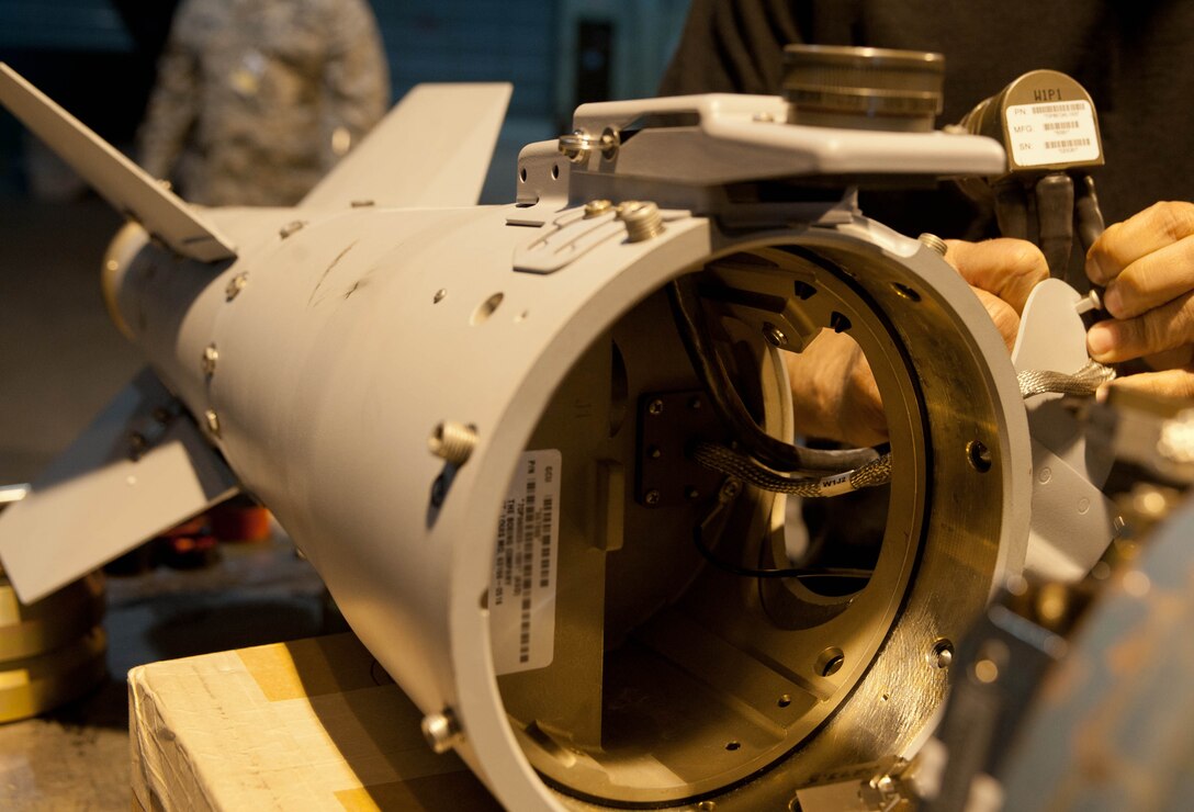 Roy Sincore, Joint Direct Attack Munitions specialist from Eglin, Fla, inspects a GBU-54 tail fin as part of a training exercise for Airmen of the 28th Munitions Squadron at Ellsworth Air Force Base, S.D., April 18, 2012. The GBU-54 is a 500-pound precision-guided weapon that delivers deadly accurate strikes against moving and stationary targets. (U.S. Air Force photo by Airman 1st Class Zachary Hada/Released)