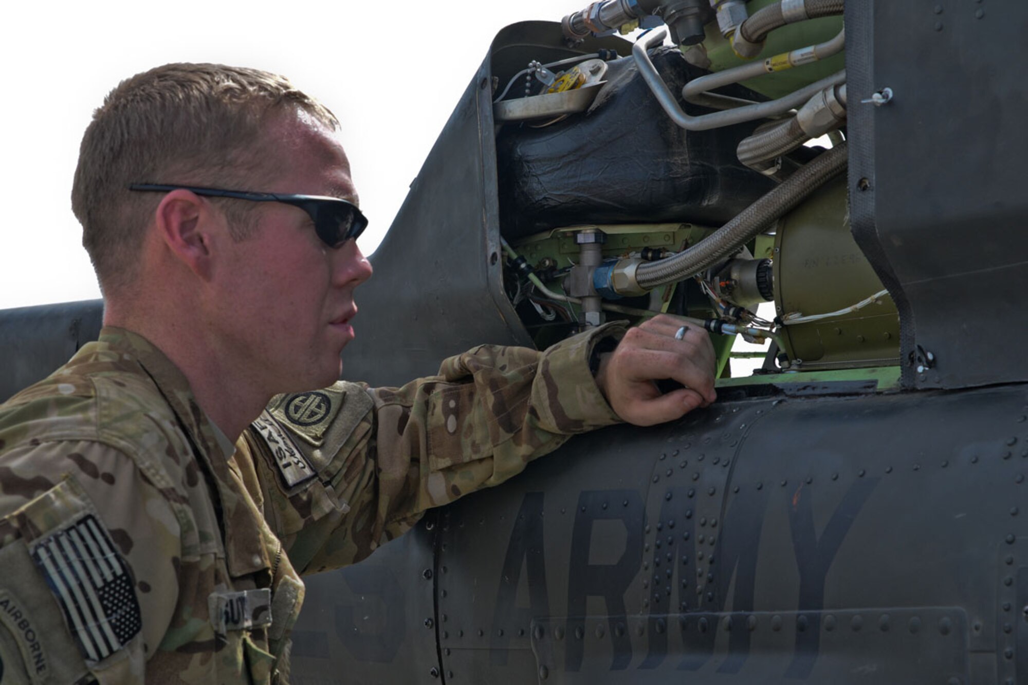 U.S. Army Sgt. Brandon Sutton, a crew chief with A Troop, 1-17 Cavalry, hailing from Dallas, works on a Kiowa Warrior OH-58D (R) helicopter at Forward Operating Base Salerno May 9. (U.S. Army Photo/Spc. Eric-James Estrada)