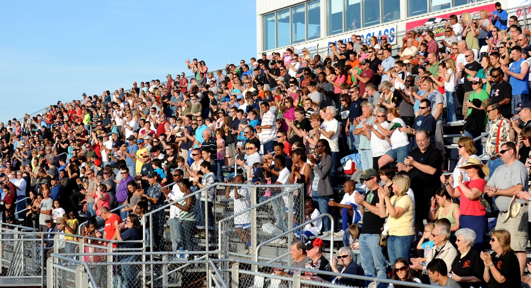 The crowd applauds U.S. Coast Guard Lt. Michelle Schopp for her performance of the national anthem at Langley Motor Speedway in Hampton Va. for Military Appreciation Night May 19. Military members and dependents were allowed free entry to the races for the evening. (U.S. Air Force photo by Airman 1st Class Austin Harvill/Released) 