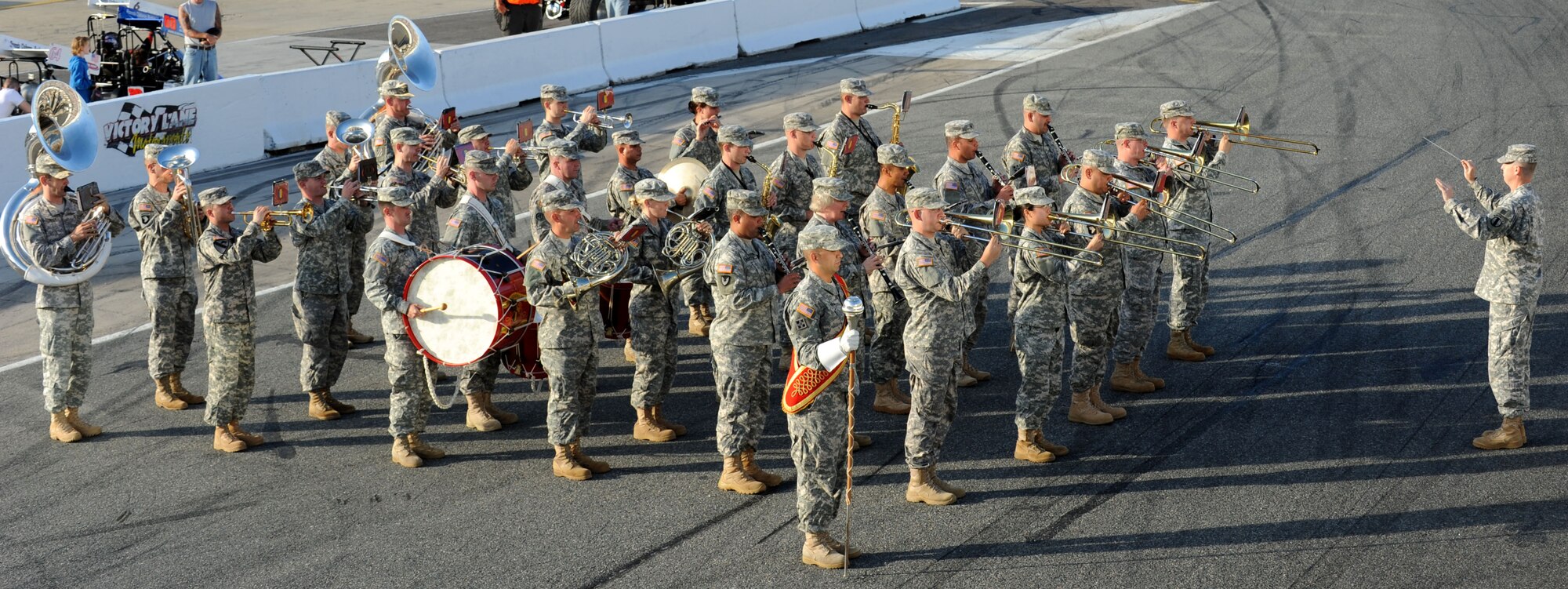 The U.S. Army Training and Doctrine Command band plays the Armed Forces Medley at the Langley Motor Speedway in Hampton, Va. during Military Appreciation Night May 19. Each segment of the song was met with cheers from speedway participants. (U.S. Air Force photo by Airman 1st Class Austin Harvill/Released) 