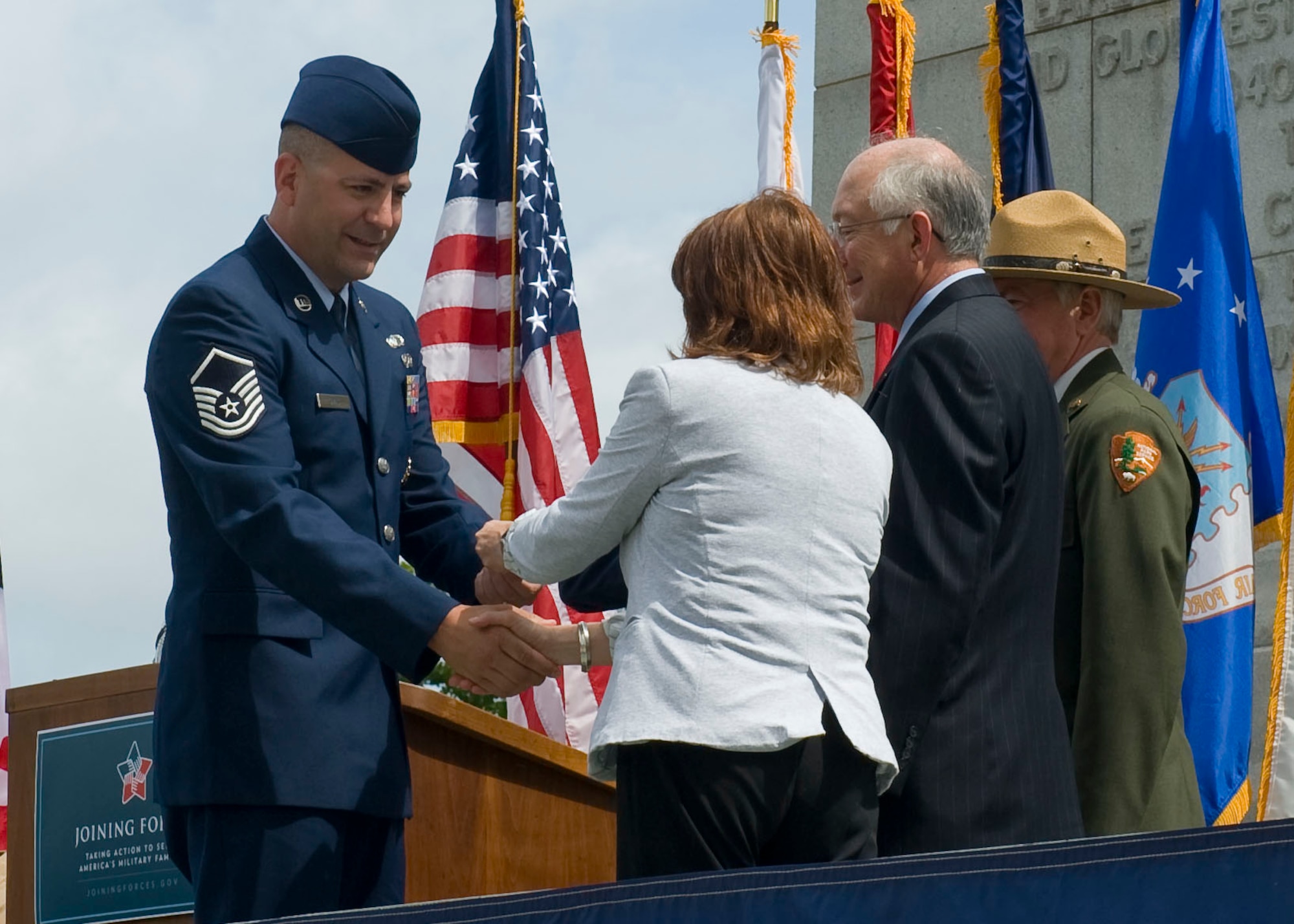 Master Sgt. Jason Simas, 633rd Contracting Squadron, receives his America the Beautiful National Parks and Federal Recreation Lands Annual Pass May 15, 2012, from Ken Salazar, Secretary of Interior, Jo-Ellen Darcy, Assistant Secretary of the Army and Jon Jarvis, National Park Service Director. Active-duty Service members and family members can obtain the new military version of the America the Beautiful National Parks and Federal Recreation Lands Annual Pass for free. (U.S. Air Force photo by Senior Airman John D. Strong II/Released)