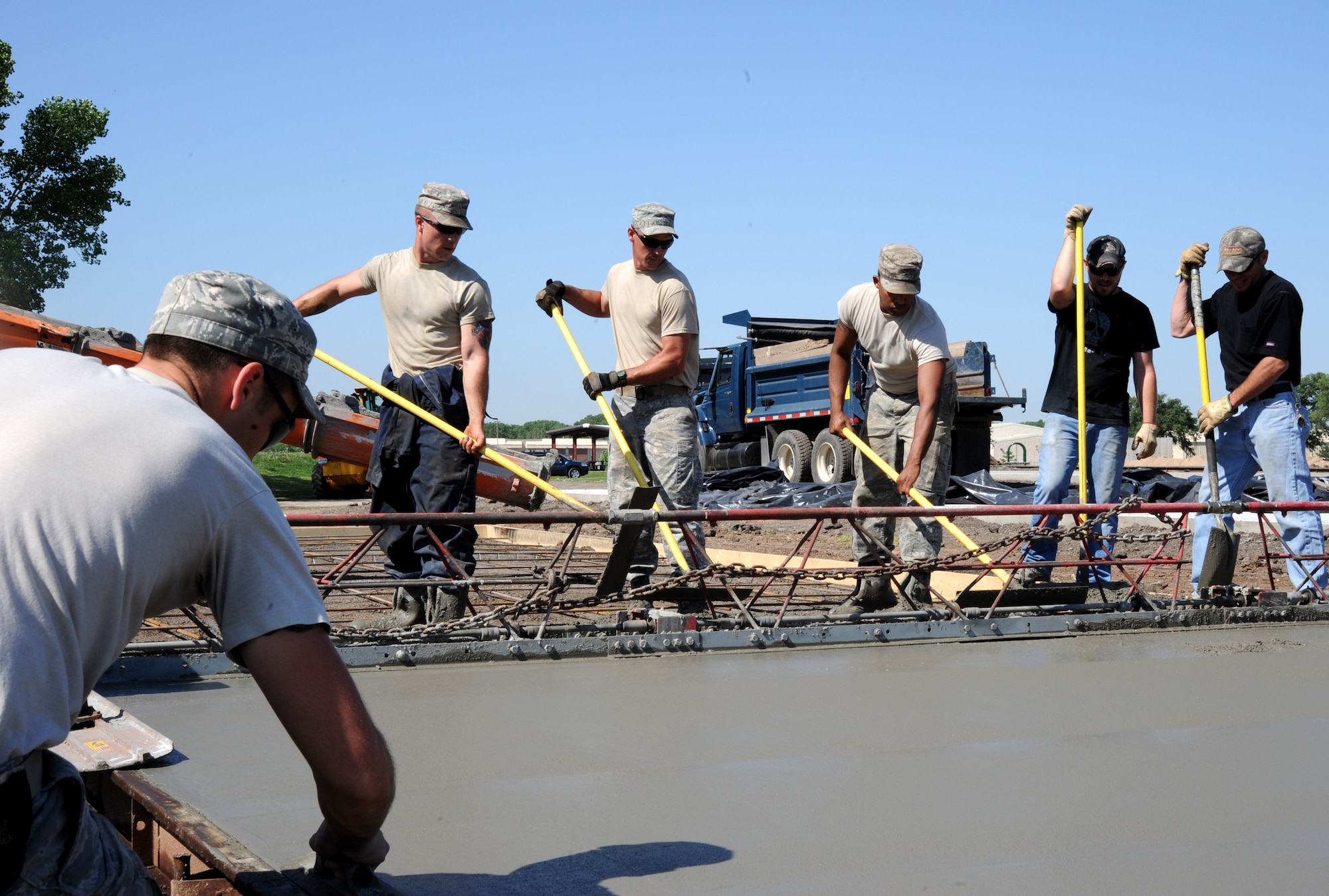 Airmen from the 22nd Civil Engineer Squadron structures shop lay concrete for a new recreational vehicle space at the Krueger Recreation Area May 16, 2012, McConnell Air Force Base, Kan. Civil engineers and Outdoor Recreation Department are working to relocate the existing family-camp area to an area with improved amenities. (U.S. Air Force photo/ Airman 1st Class Laura L. Valentine)