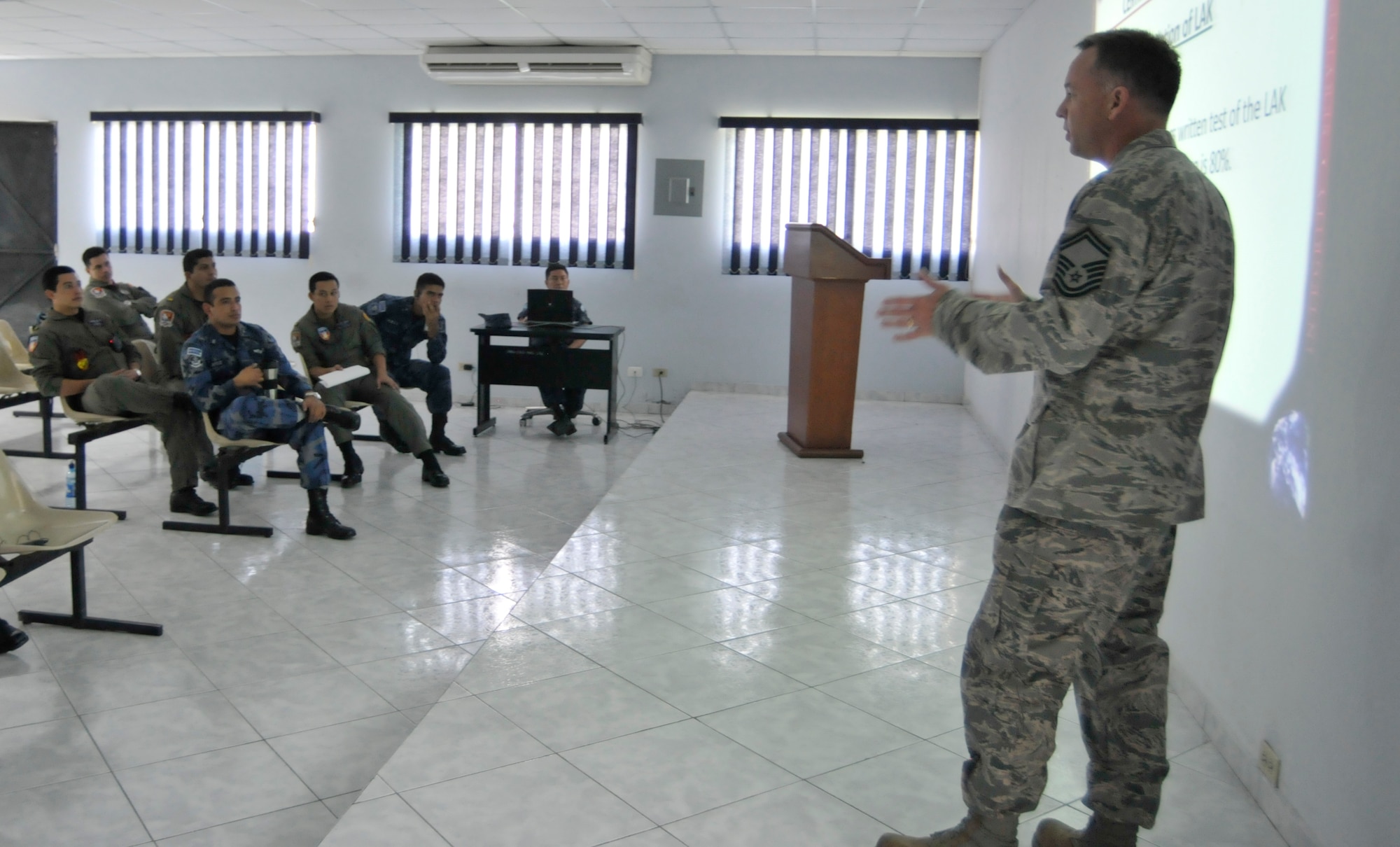 Senior Master Sgt. Richard Reed, 260th Air Traffic Control Squadron, briefs El Salvadoran Air Force air traffic controllers on how the Air National Guard trains their own air traffic controllers, as part of a week long Subject Matter Expert Exchange (SMEE) between the N.H. Air National Guard and the El Salvadoran Air Force, San Salvador, El Salvador, May 7 through 11, 2012.  This SMEE is part of the National Guard State Partnership Program. (Released/National Guard photo by Tech. Sgt. Aaron Vezeau)