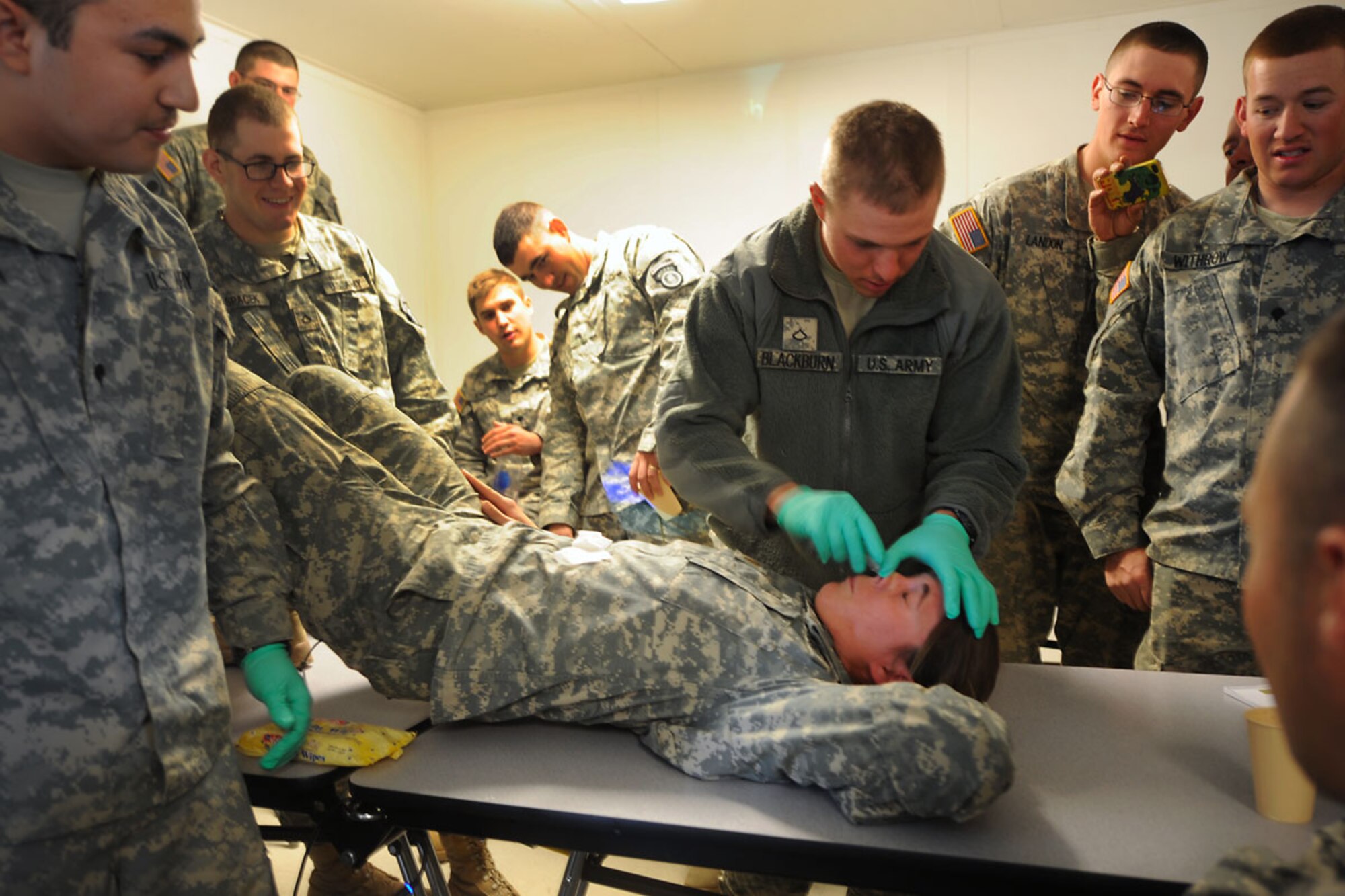 DONNELLY TRAINING AREA, Alaska -- Private Donald Blackburn adminsters the nasopharyngeal aparatus to 2nd Lt. Blaise Gill to demonstrate its application during combat lifesaver training May 10. Members of the 84th Engineer Support Company, 6th Engineer Battalion, Joint Base Elmendorf-Richardson, takes this class for annual retraining. Gill is the 1st platoon leader and Blackburn horizontal construction operator both with the 84th ESC. (U.S. Air Force photo by Staff Sgt. Cynthia Spalding)