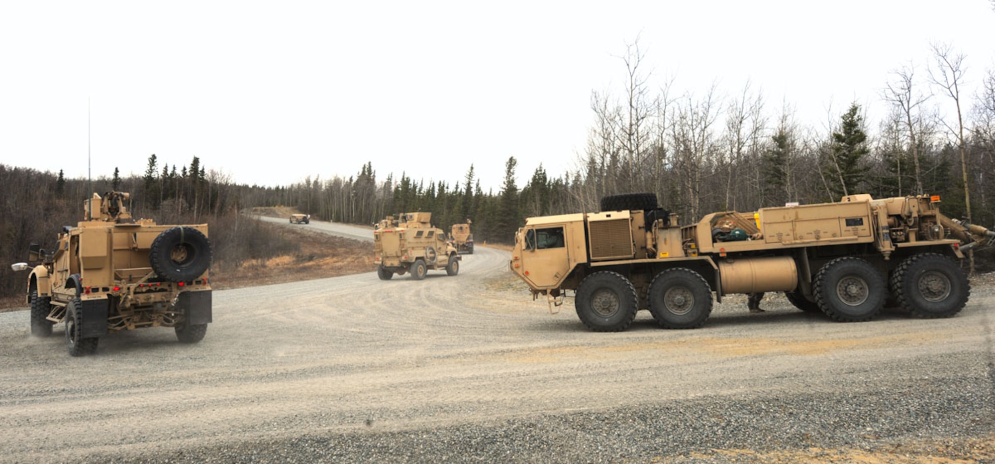 DONNELLY TRAINING AREA, Alaska -- A route-clearing convoy moves during a simulated route-clearance mission May 10. The 84th Engineer Support Company, 6th Engineer Battalion, Joint Base Elmendorf-Richardson, whose specialty was not clearing roadways for convoys, has been tasked to reshape their forces for a route-clearing mission. Their new job is to now go out searching for and investigating any roadside bombs or mines so that others may pass through quickly and safely. (U.S. Air Force photo by Staff Sgt. Cynthia Spalding)