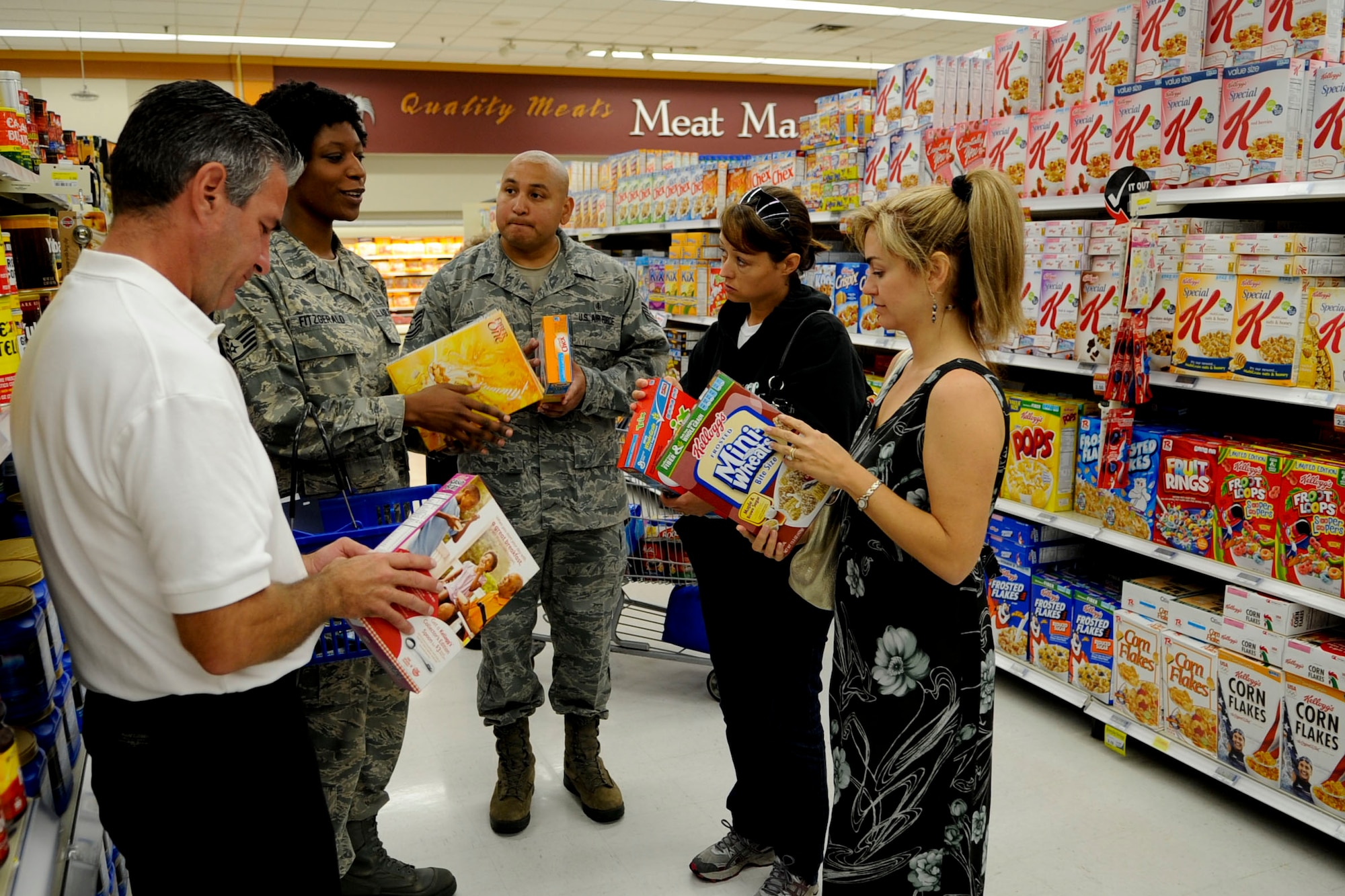 U.S. Air Force Staff Sgt. Shelia Fitzgerald, 2nd from the left, 633rd Medical Support Squadron Health and Wellness Center NCO in-charge, explains how to read the nutrition labels on a box of cereal during the “Ace Those Aisles” class at the Langley Air Force Base commissary, May 21, 2012. Participants also learned what to look for on nutrition labels, such as five grams of fiber is considered great for an individual food item.  (U.S. Air Force photo by Senior Airman Wesley Farnsworth/Released)