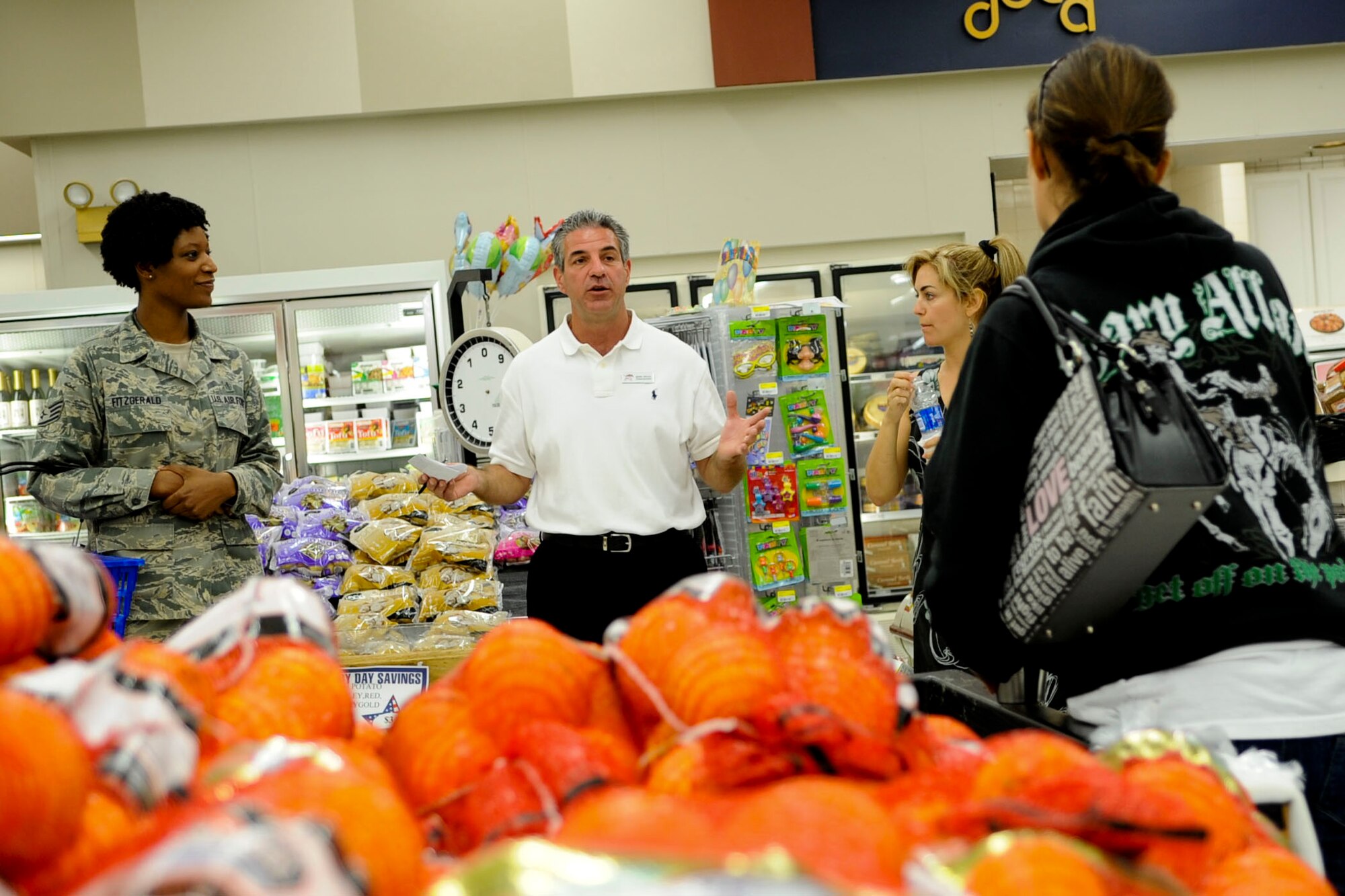 Mark Vecca, center, Langley Air Force Base Commissary store manager, gives participants of the “Ace Those Aisles” class some background information on how the commissary operates at Langley AFB, Va., May 21, 2012. During the class, participants received a tour of the commissary, and tips on how to buy and eat healthier foods. (U.S. Air Force photo by Senior Airman Wesley Farnsworth/Released)
