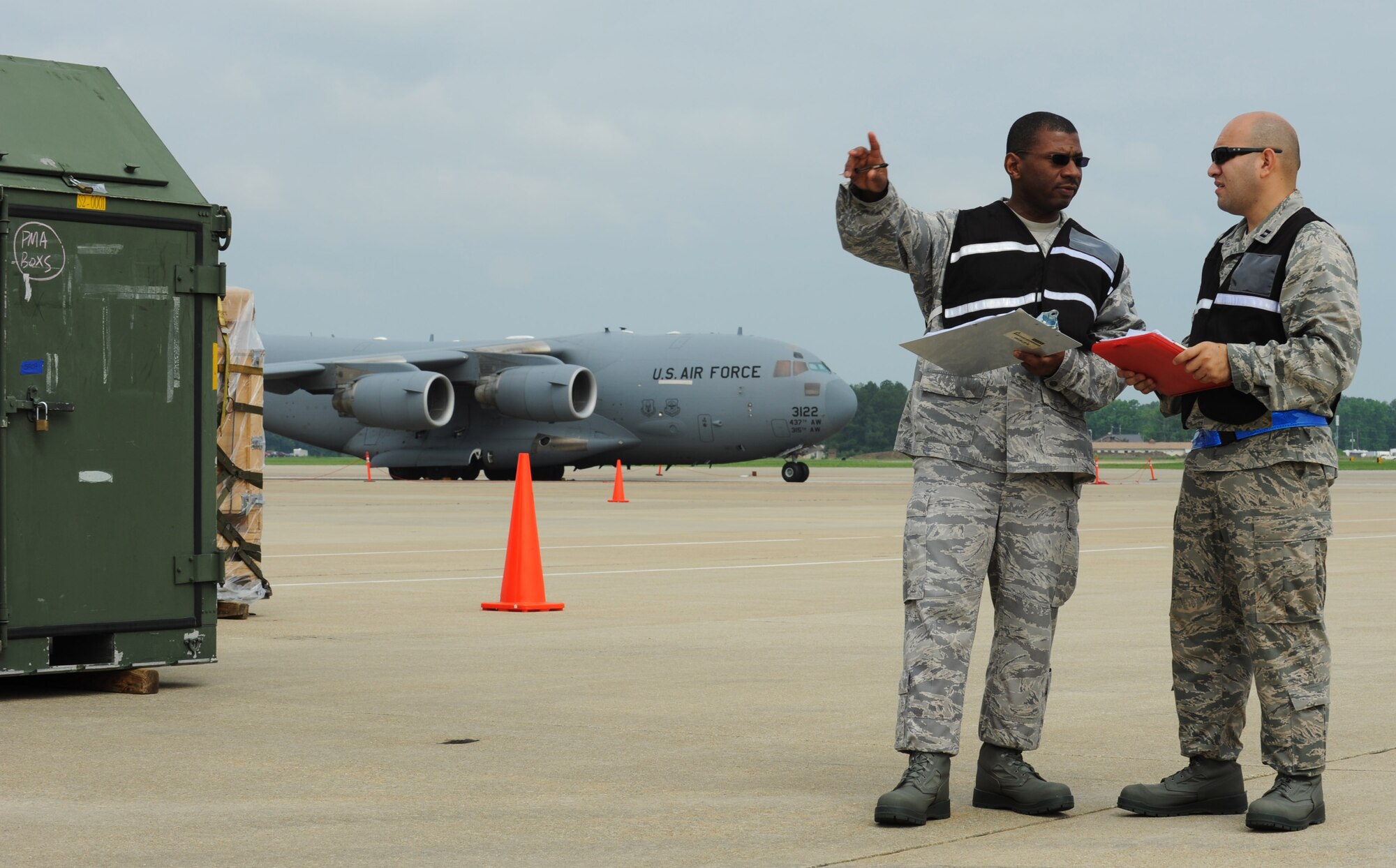 Master Sgt. Willie Cunningham, left, 633rd Logistics Readiness Squadron cargo deployment function superintendent, identifies the completed pallets to Capt. Jose Crespo, 633rd LRS deployment and distribution flight commander, at Langley Air Force Base, Va., May 17, 2012. The pallets were scheduled to be loaded onto a C-17 Globemaster III for an upcoming deployment. (U.S. Air Force photo by Senior Airman Jarad A. Denton/Released)