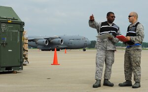 Master Sgt. Willie Cunningham, left, 633rd Logistics Readiness Squadron cargo deployment function superintendent, identifies the completed pallets to Capt. Jose Crespo, 633rd LRS deployment and distribution flight commander, at Langley Air Force Base, Va., May 17, 2012. The pallets were scheduled to be loaded onto a C-17 Globemaster III for an upcoming deployment. (U.S. Air Force photo by Senior Airman Jarad A. Denton/Released)