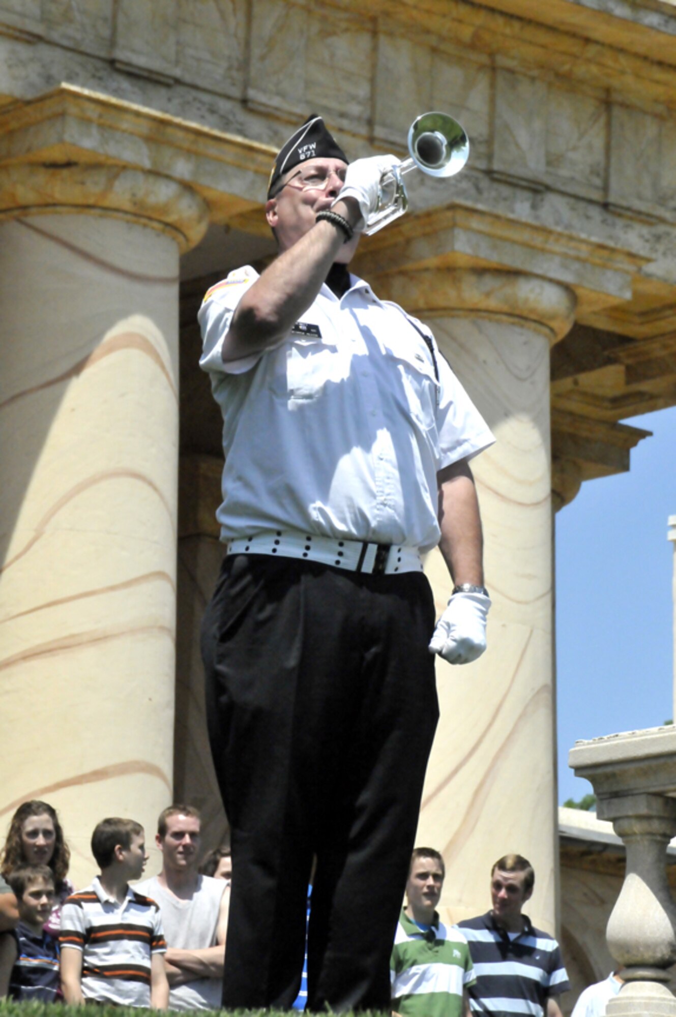 Overlooking Arlington National Cemetery and Washington, D.C., bugler George Allen of DeWitt, Mich. plays the bugle call taps in front of Arlington House May 19, 2012. Allen was part of a 200-person collective rendition of taps which was played at noon throughout the cemetery. (Photo by Jim Dresbach)