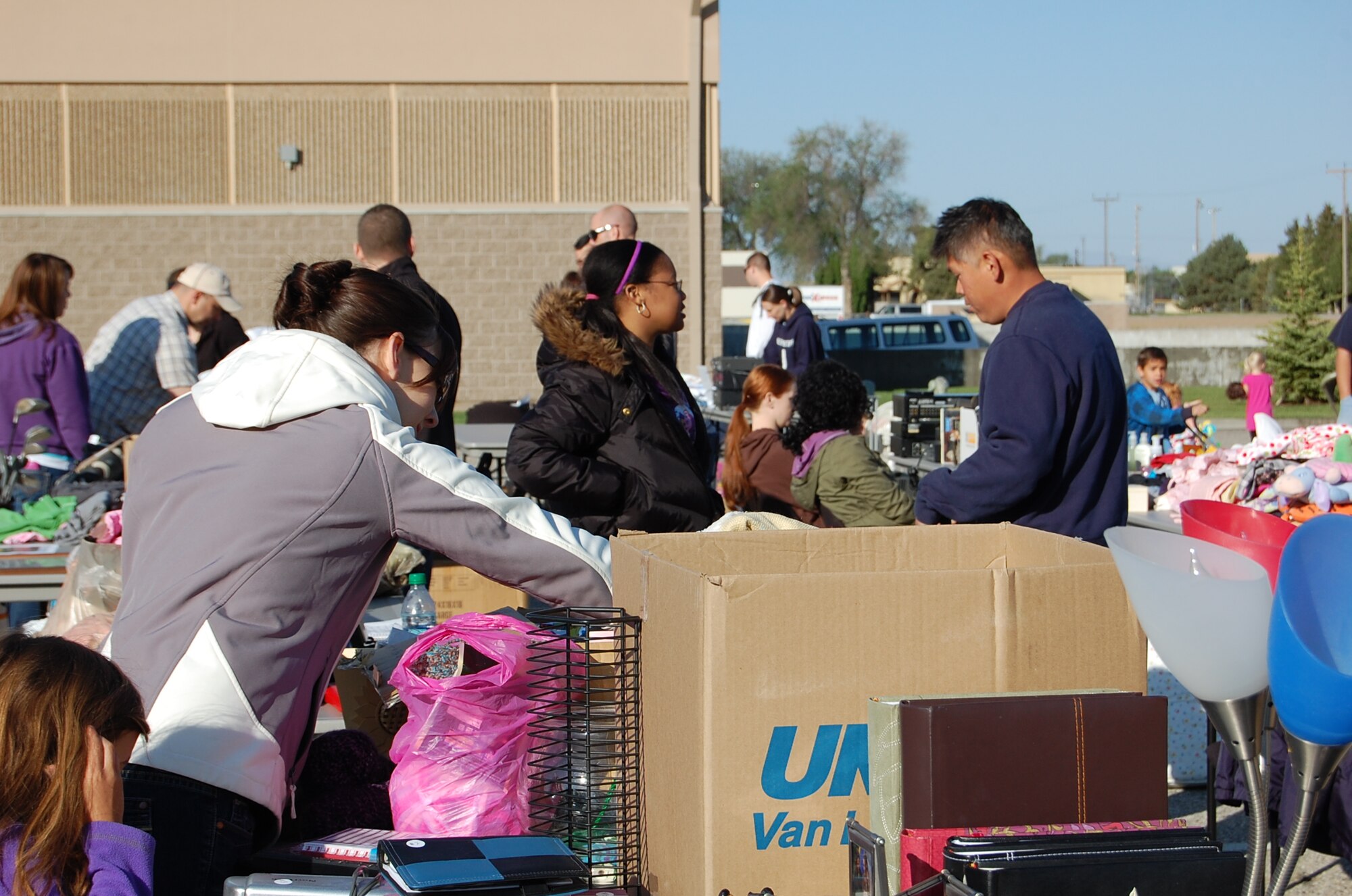 Shoppers peruse items offered by some 26 vendors at a community yard sale hosted by the 366th Force Support Squadron May 19, 2012, at the Gunfighter Service Center on Mountain Home Air Force Base, Idaho. Some of the thousands of items sold included furniture, jewelry, bicycles, clothes and home electronics. A number of vendors planned to donate their unsold items to the Airmen’s Attic, Gunfighter thrift store or other local charities such as the Idaho Youth Ranch. (U.S. Air Force photo/2nd Lt. David Liapis)