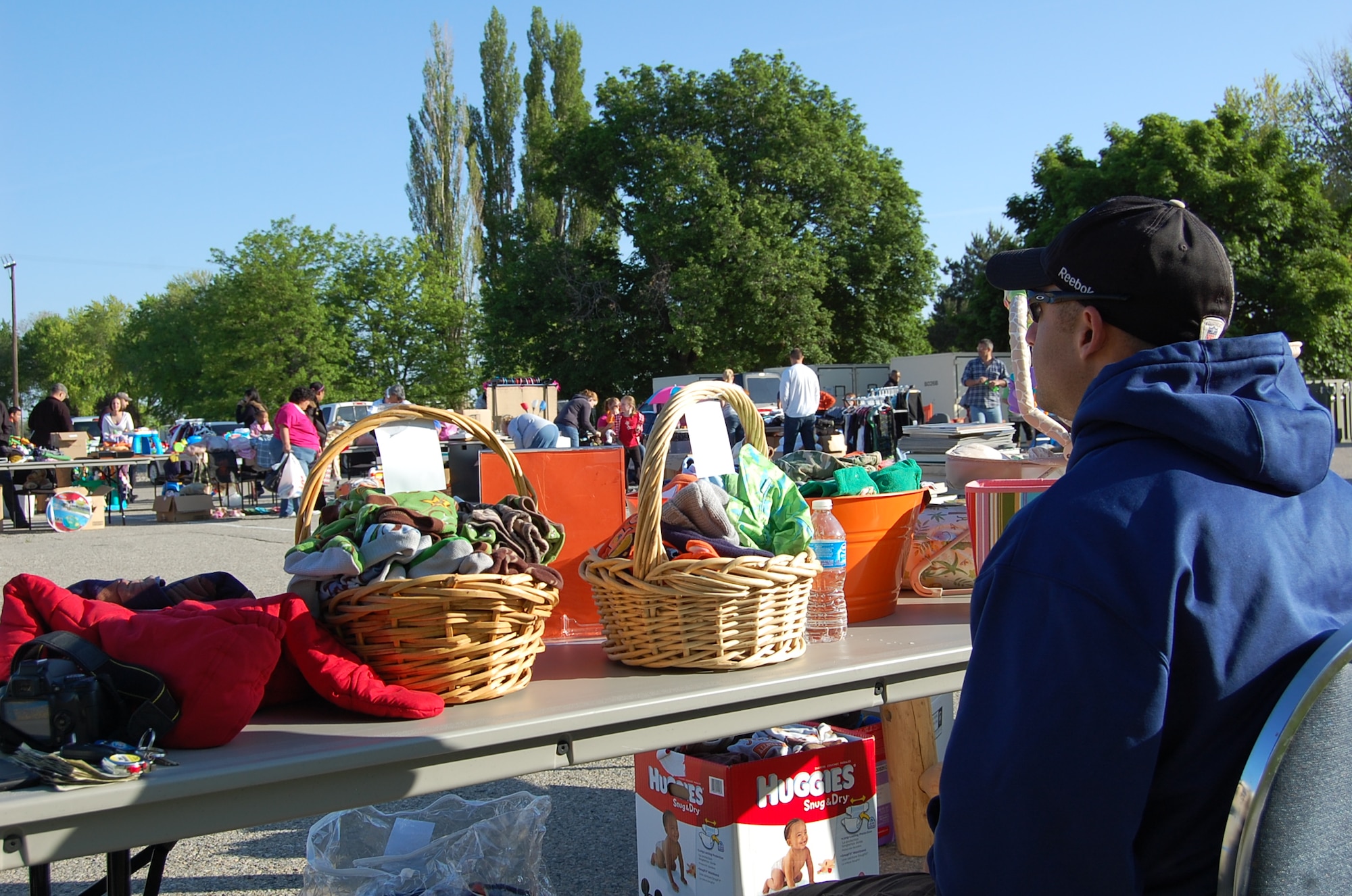 Tech. Sgt. Ryan Hendrickson, one of 26 vendors at a community yard sale hosted by the 366th Force Support Squadron, awaits shoppers to visit his table May 19, 2012, at the Gunfighter Service Center on Mountain Home Air Force Base, Idaho. The event, which according to 366th FSS staff will not be the last one this summer, drew approximately 250 shoppers. (U.S. Air Force photo/2nd Lt. David Liapis)