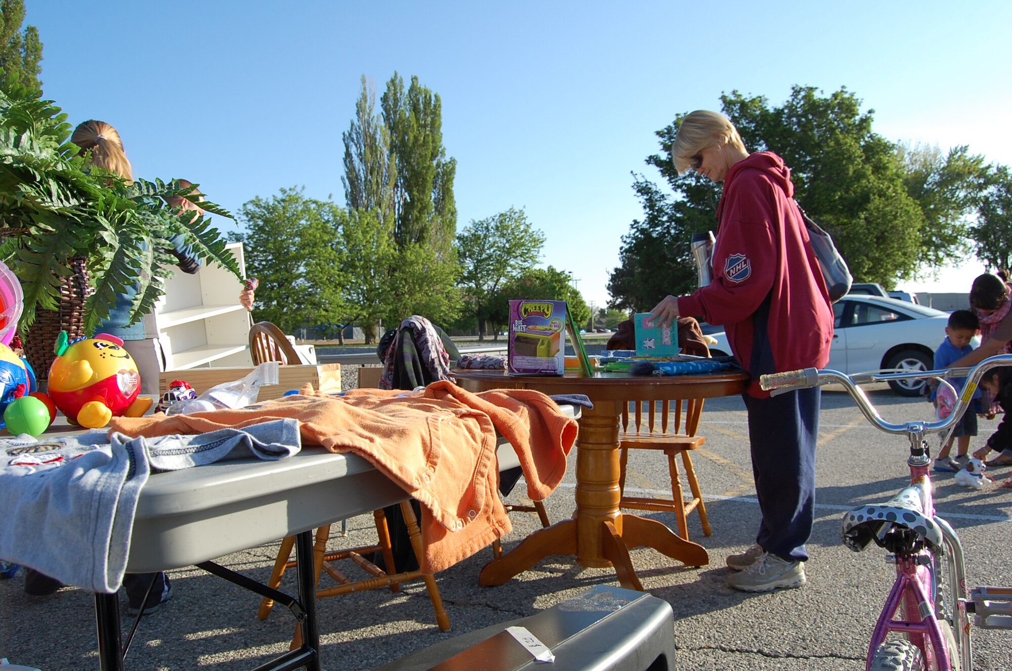 The sun shines brightly and gusty winds settle down just in time for 26 vendors to set up their wares for shoppers to examine at a community yard sale hosted by the 366th Force Support Squadron May 19, 2012, in the parking lot of the Gunfighter Service Center on Mountain Home Air Force Base, Idaho. Sale-goers found amazing deals on quality items and benefitted from a consolidated shopping location. (U.S. Air Force photo/2nd Lt. David Liapis)