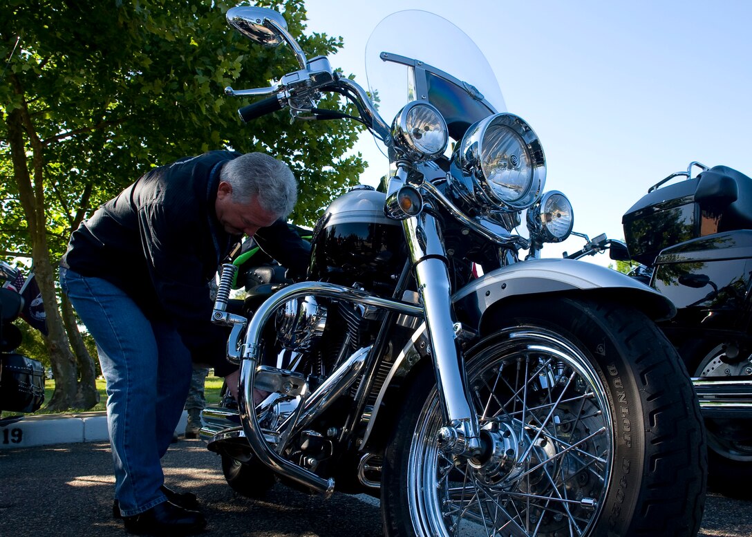 Jeff Tobin, 633rd Air Base Wing Anti-Terrorism Office, inspects his Harley Davidson motorcycle at the 2012 Joint Base Langley-Eustis Armed Forces Motorcycle Ride and Rodeo at Fort Eustis, Va., May 11, 2012 . The annual event, which is held each May to promote Motorcycle Safety Awareness Month, featured a bike show, rider skills challenges, trophies, prizes and more. (U.S. Air Force photo by Senior Airman John D. Strong II/Released)
