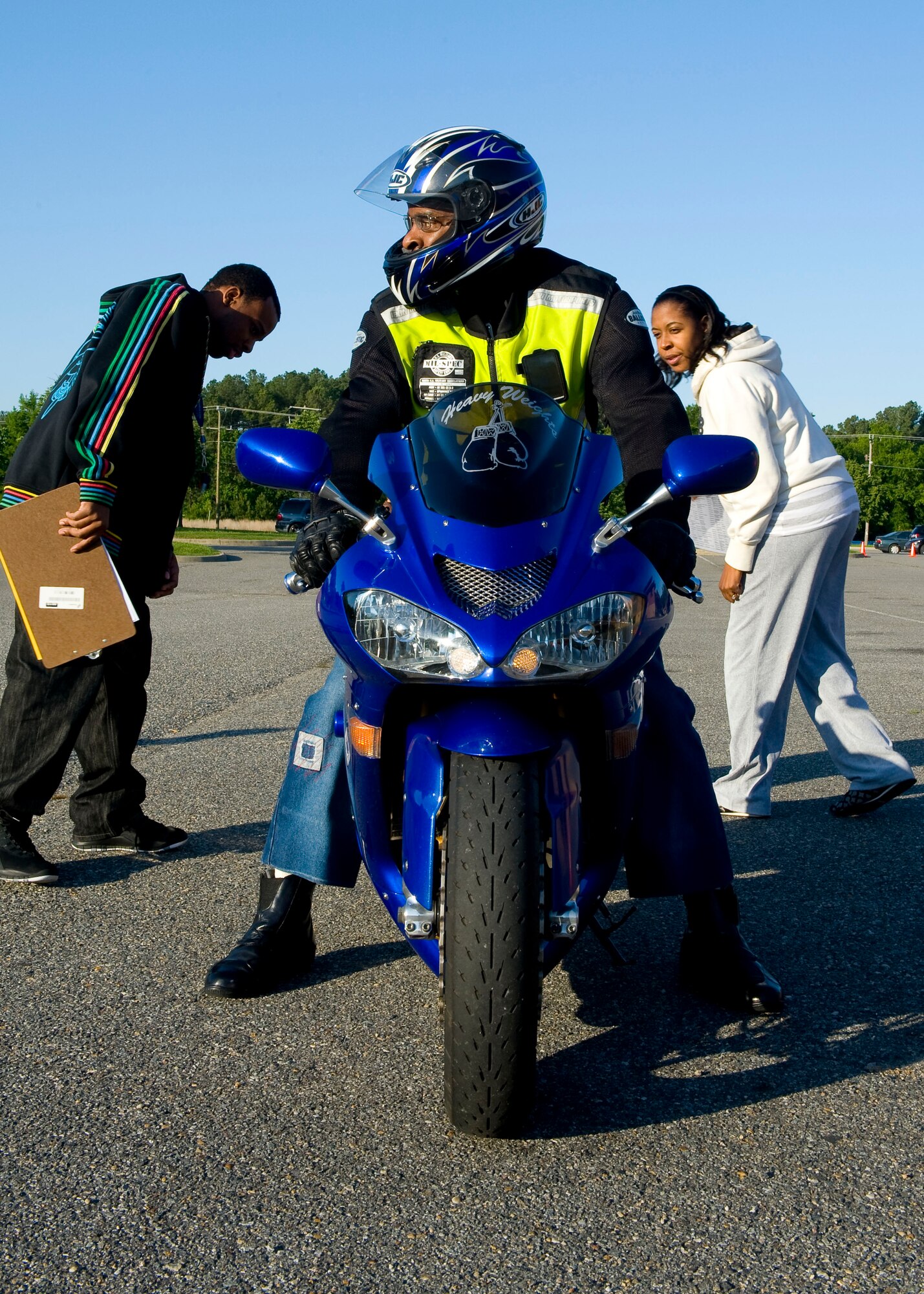 U.S. Air Force Tech. Sgt. Kimberly Young and Staff Sgt. Corey Lusk, 633rd Air Base Wing Safety Office, inspect the rear turn signals on Randolph Singelton’s Kawasaki ZX-10R during the 2012 Joint Base Langley-Eustis Armed Forces Motorcycle Ride and Rodeo at Fort Eustis, Va., May 11, 2012. Singleton, from the  U.S. Army Public Health Command, was among more than 300 motorcycle riders who brought their bikes to Fort Eustis to share the spirit of safety, and enjoy a day of beautiful springtime riding weather. (U.S. Air Force photo by Senior Airman John D. Strong II/Released) 
