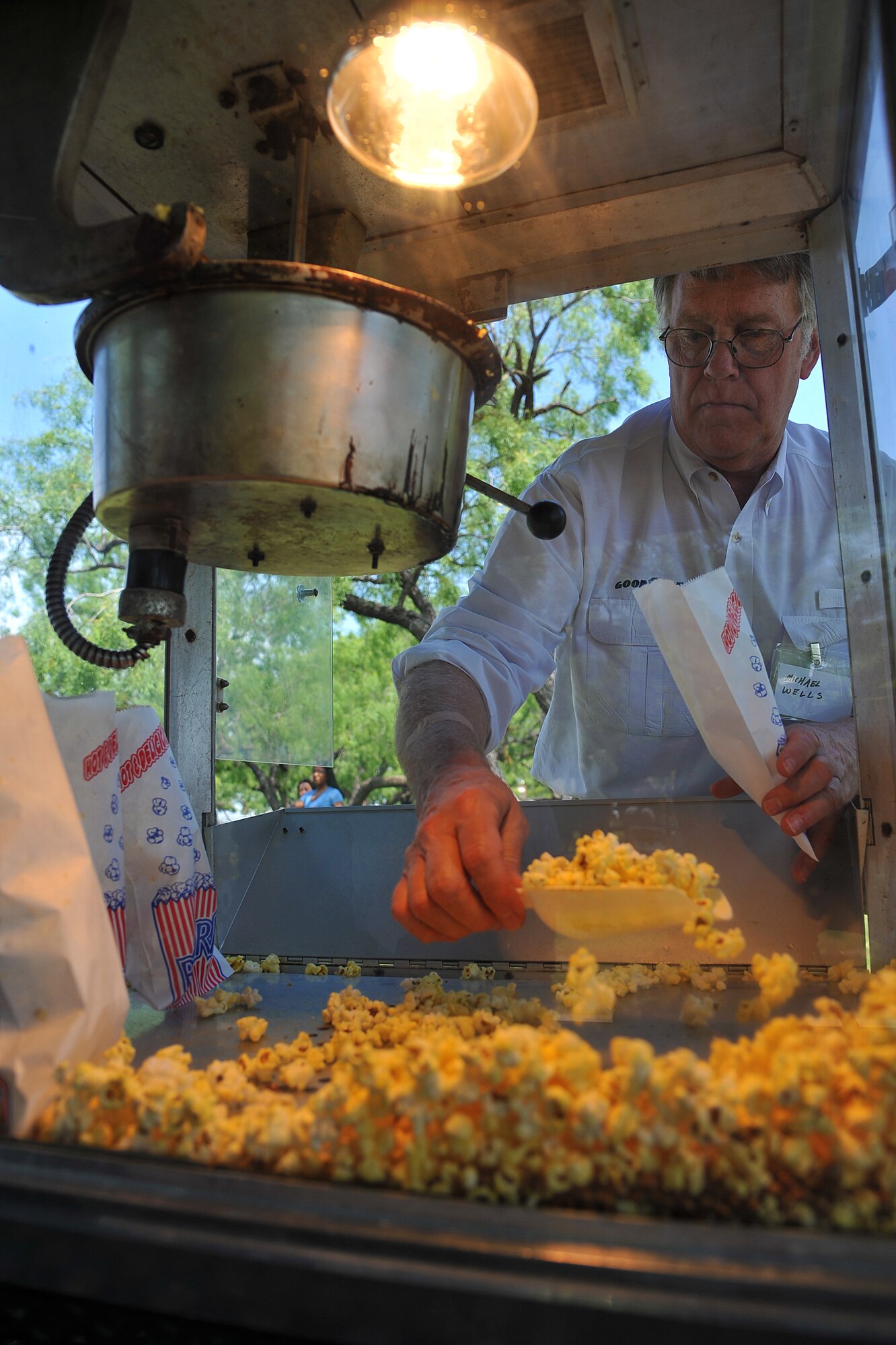 GOODFELLOW AIR FORCE BASE, Texas-- Michael Wells, volunteer, scoops popcorn into a bag during Goodfellow Appreciation Day held at the Recreational Camp May 19. The San Angelo community sponsored the 7th annual Goodfellow Appreciation Day and provided food, fun and activities to Team Goodfellow (U.S. Air Force photo/Airman 1st Class Michael Smith)