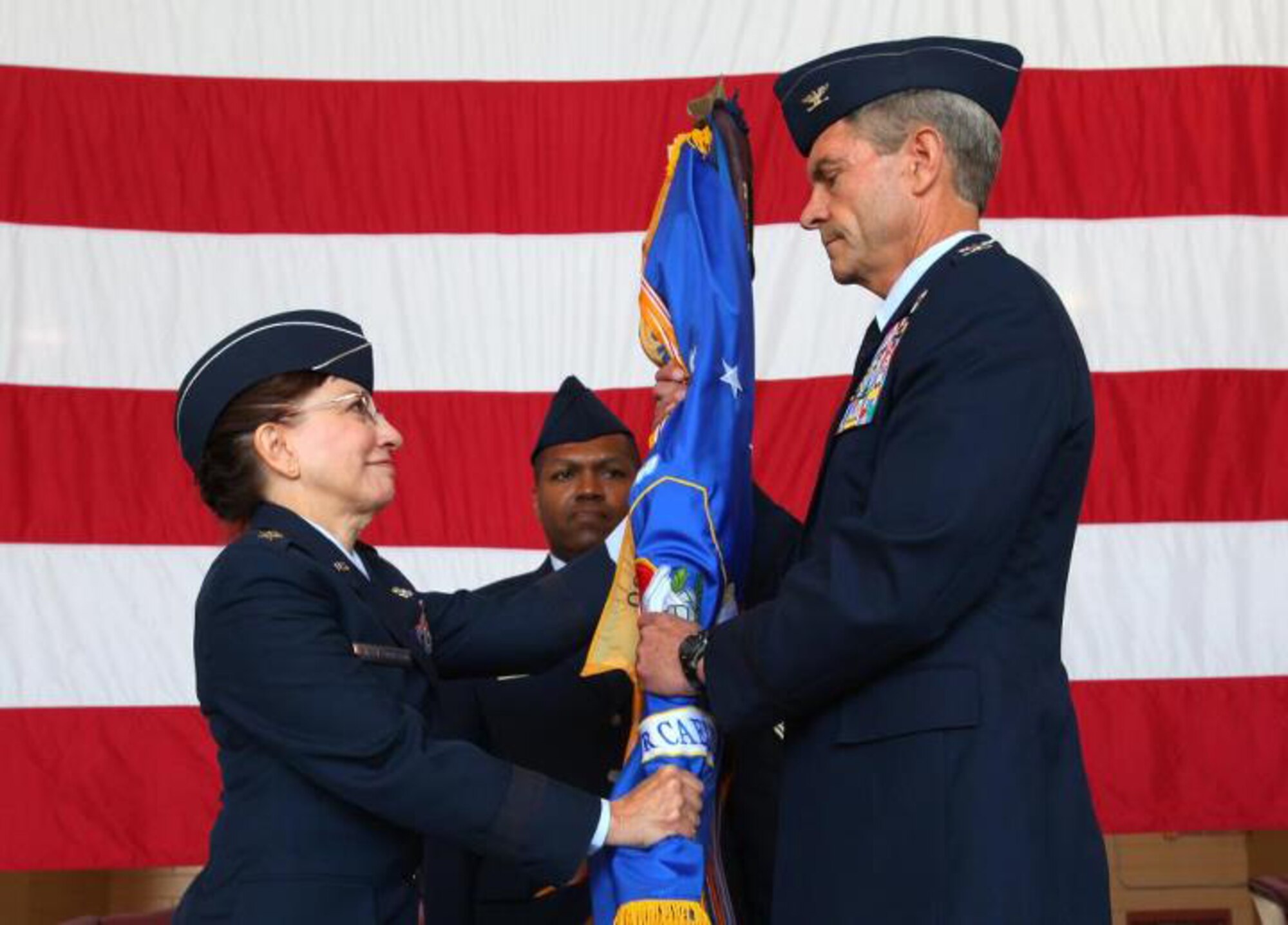Col. Kevin J. Keehn, right, incoming 108th Wing commander, accepts the Wing's guidon from Maj. Gen. Maria Falca-Dodson, New Jersey Air National Guard commander, during a Change of Command ceremony May 20, 2012 at Joint Base McGuire-Dix-Lakehurst, N.J. Keehn took over command from outgoing commander Brig. Gen. Michael L. Cunniff. (U.S. Air Force photo by Master Sgt. Mark C. Olsen, 177th Fighter Wing Public Affairs) Master Sgt. Mark C. Olsen