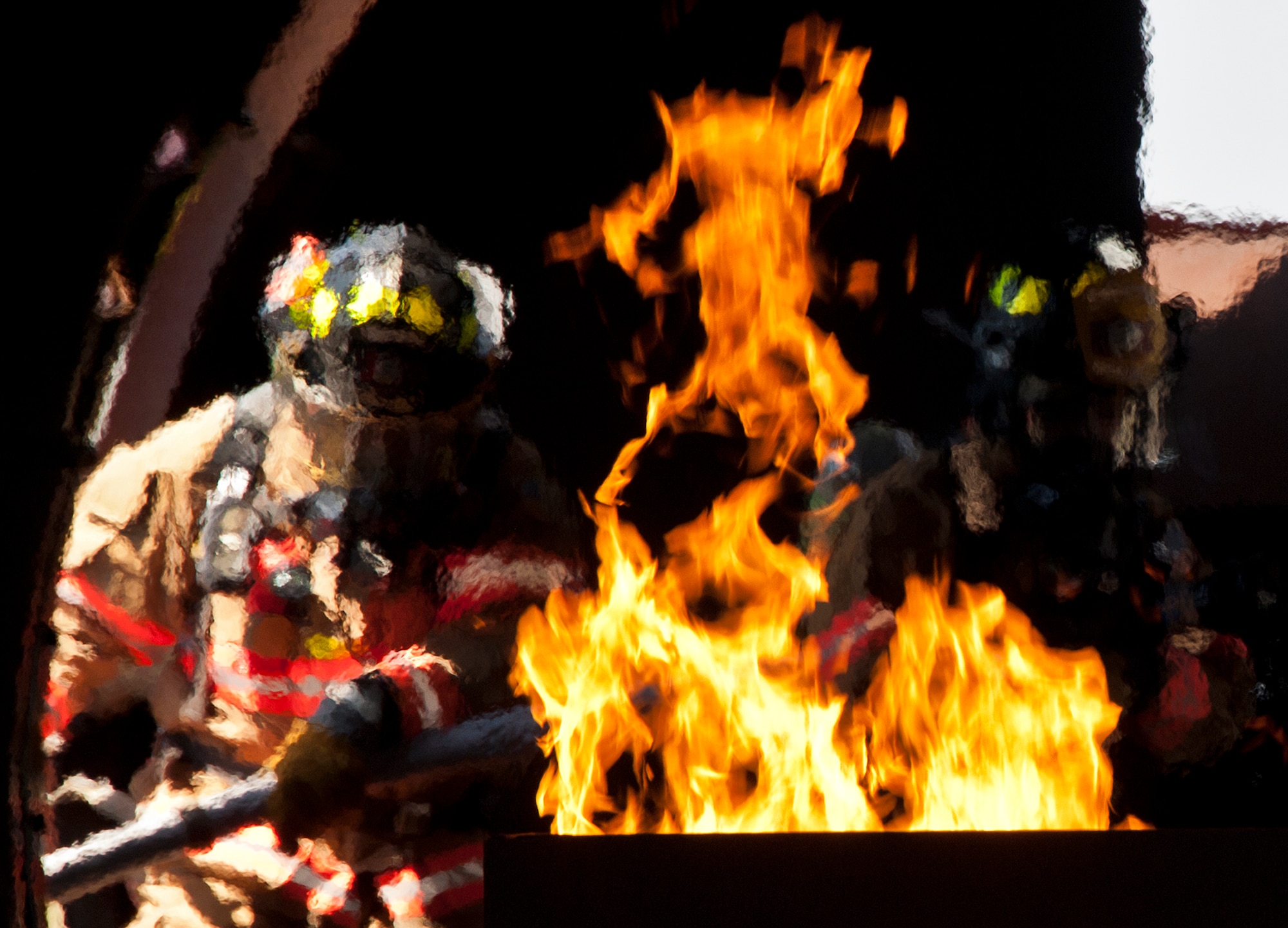 A two-man firefighting team enters the aircraft from the wing to battle a fire in the tail section during a live-fire exercise at Eglin Air Force Base, Fla.  The aircraft fire training is a yearly requirement for Eglin’s Airmen and civilian firefighters.  The firefighters must battle a fire on the inside and outside of the aircraft to complete the training.  (U.S. Air Force photo/Samuel King Jr.)