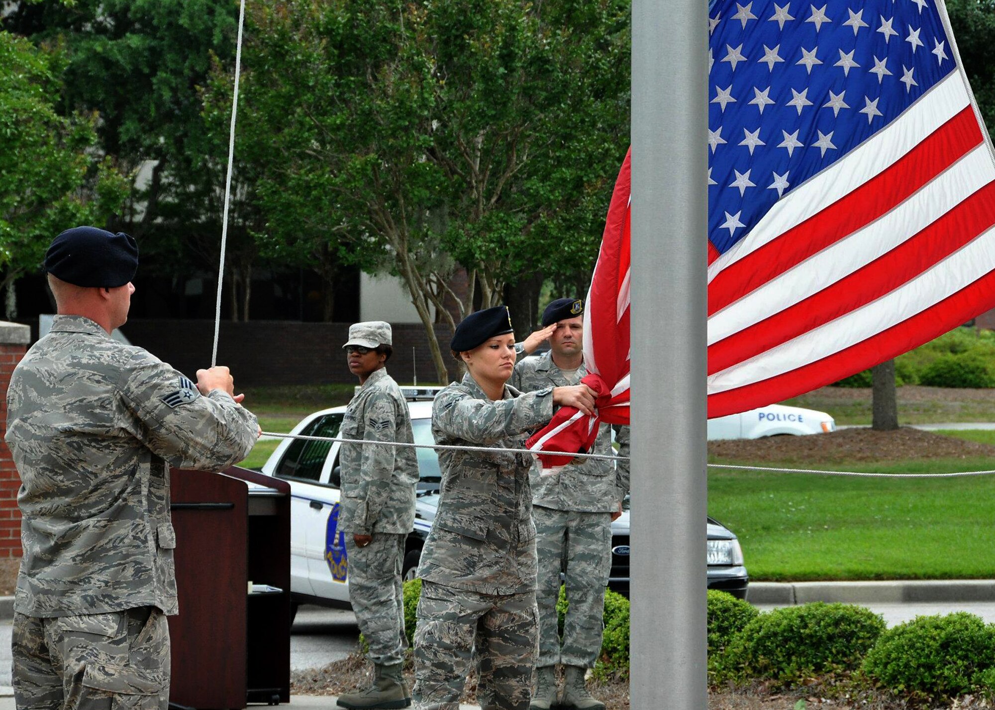 A 628th Security Forces Squadron falag detail lowers the base flag during the Joint Base Charleston 2012 National Police Week memorial retreat ceremony at the base flagpole May 18, 2012.  (U.S. Air Force photo / Michael Dukes)