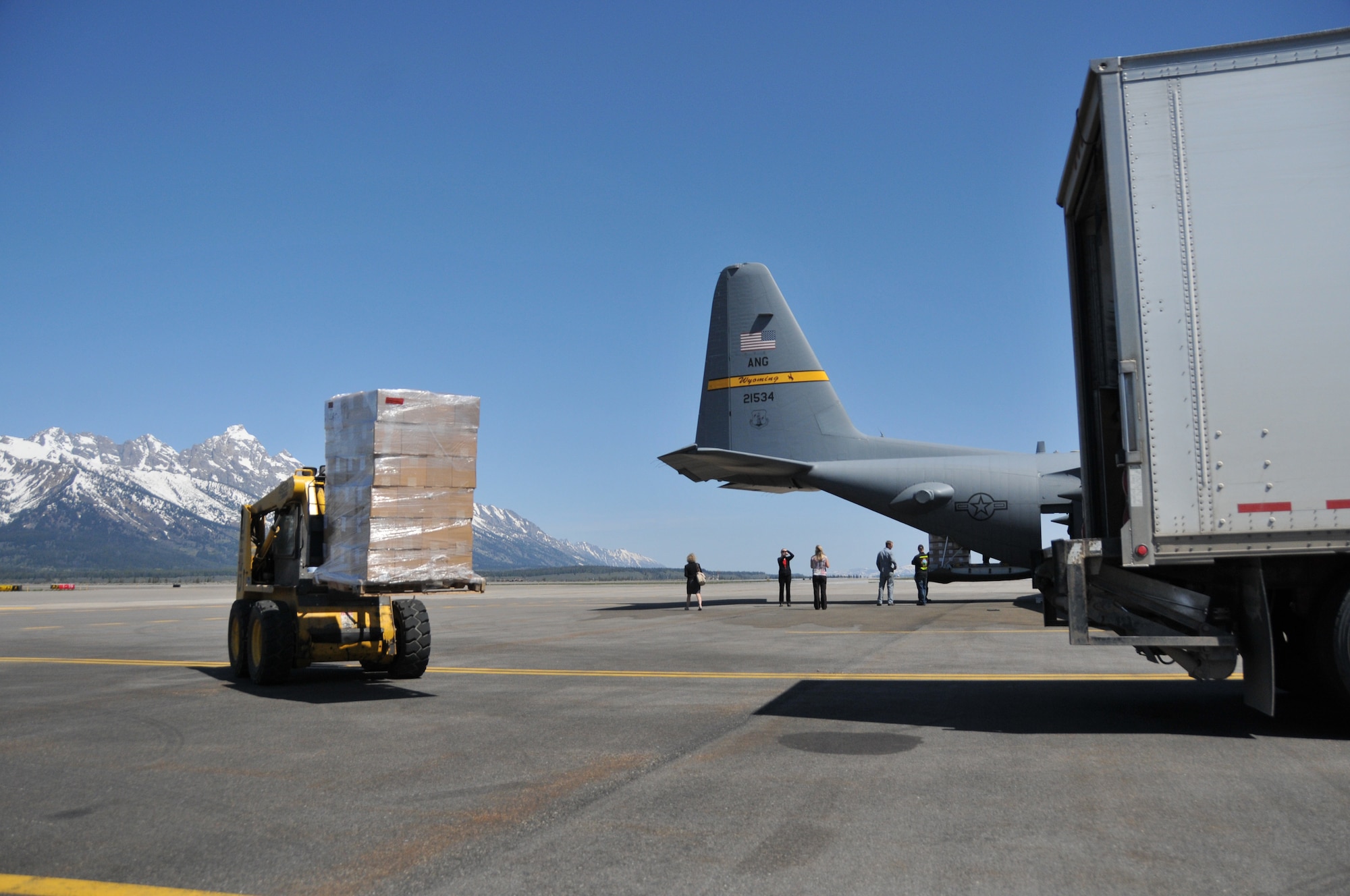 Simulated vaccine is taken from a Wyoming Air National Guard C-130 and loaded into a truck at the Jackson Hole airport as part of a Strategic National Stockpile exercise May 14, 2012. Airmen assigned to the Wyoming Air National Guard worked with multiple state agencies to test abilities to receive, deliver and distribute medical supplies to various parts of the state. (U.S. Air Force photo by 1st Lt. Rusty Ridley)
