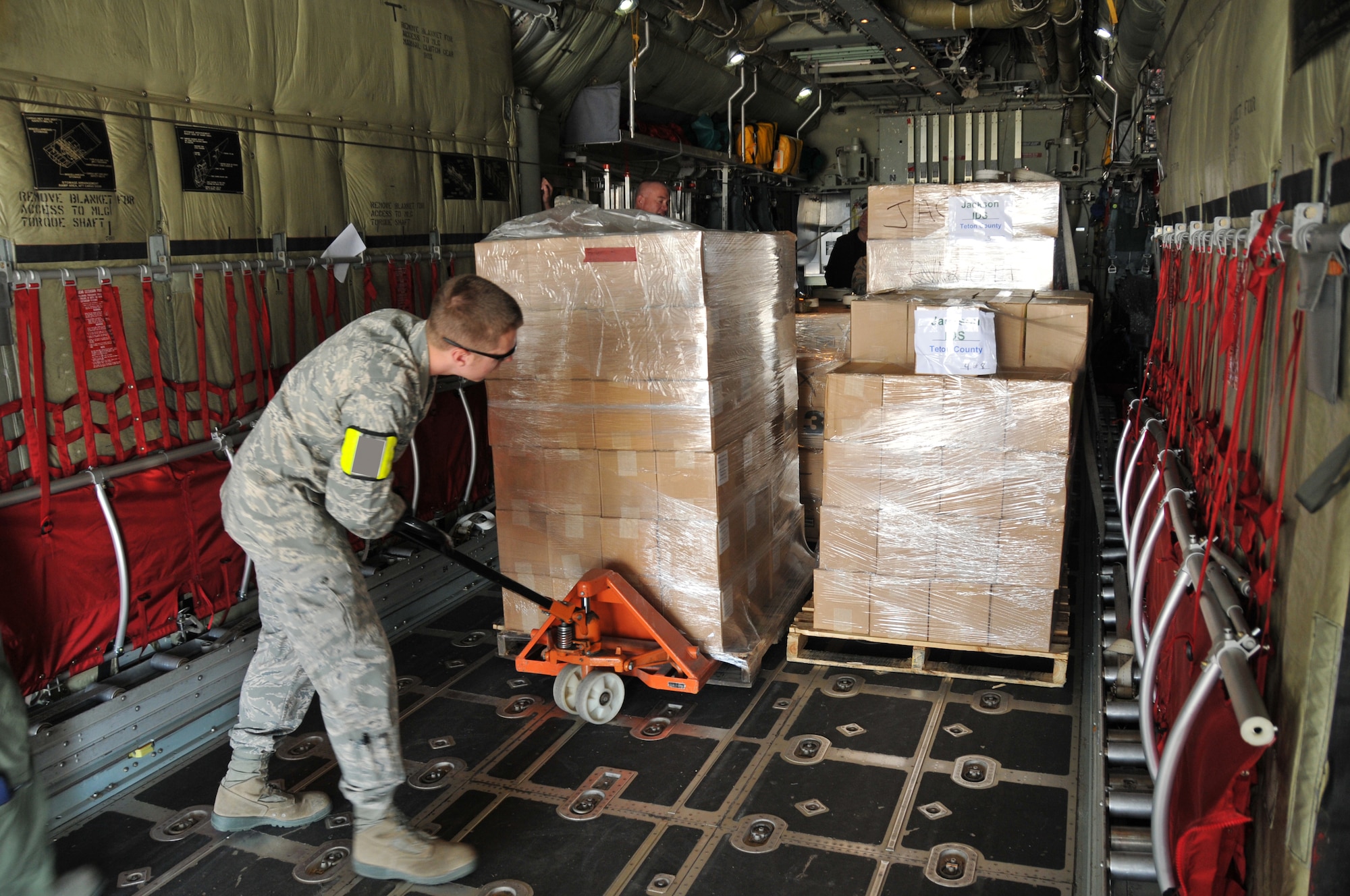 Senior Airman Jacob Lloyd, 153rd Logistics Readiness Squadron, moves simulated vaccine on a C-130 as part of a Strategic National Stockpile exercise May 14, 2012.  Airmen assigned to the Wyoming Air National Guard worked with multiple state agencies to test abilities to receive, deliver and distribute medical supplies to various parts of the state. (U.S. Air Force photo by 1st Lt. Rusty Ridley)