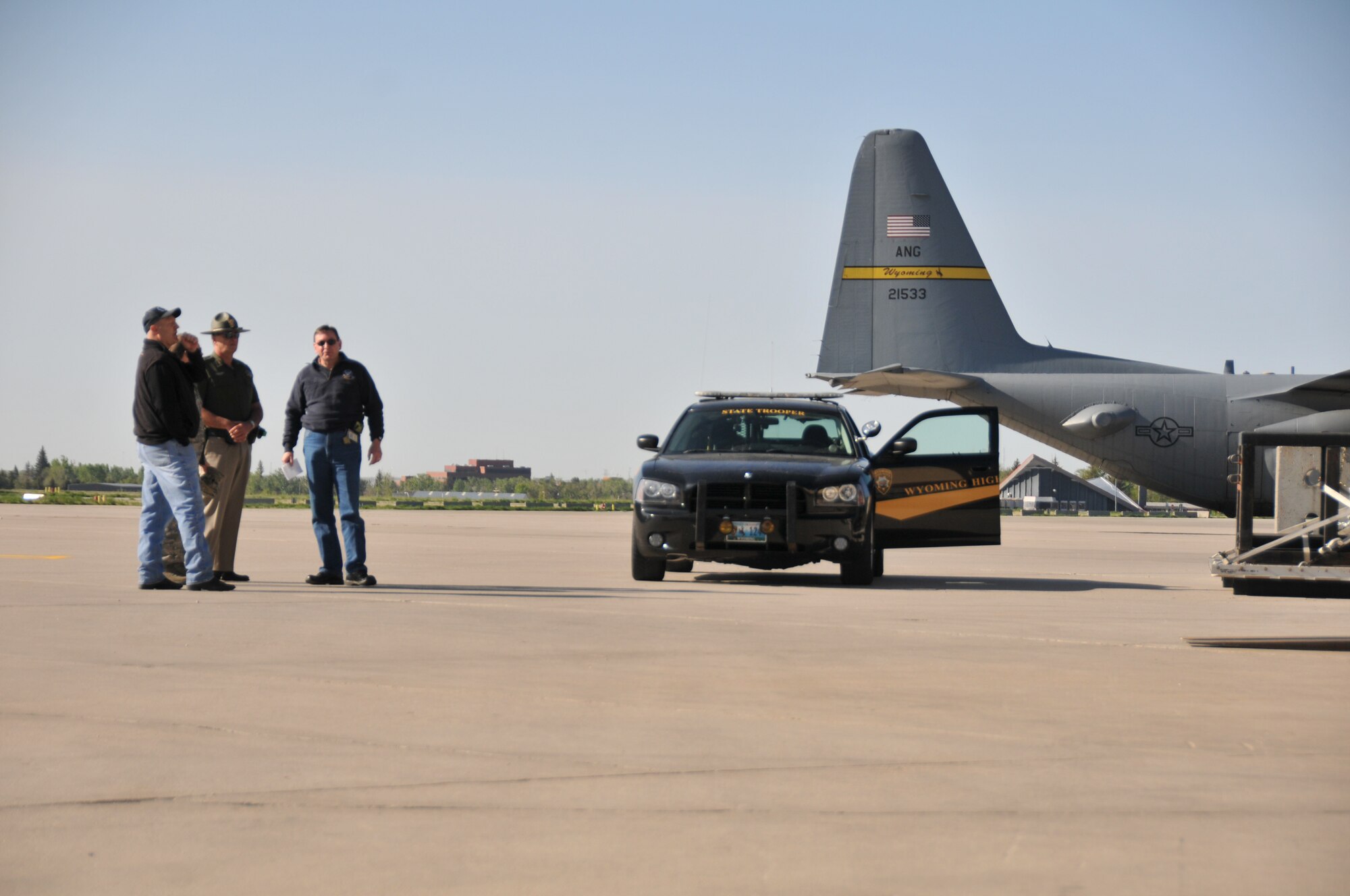 Participants from the Wyoming Department of Health, Wyoming Highway Patrol and 153rd Airlift Wing await the movement of simulated vaccine to a C-130 as part of a Strategic National Stockpile exercise May 14, 2012, at the Wyoming Air National Guard base in Cheyenne, Wyo. Airmen assigned to the Wyoming Air National Guard worked with multiple state agencies to test abilities to receive, deliver and distribute medical supplies to various parts of the state. (U.S. Air Force photo by 1st Lt. Rusty Ridley)