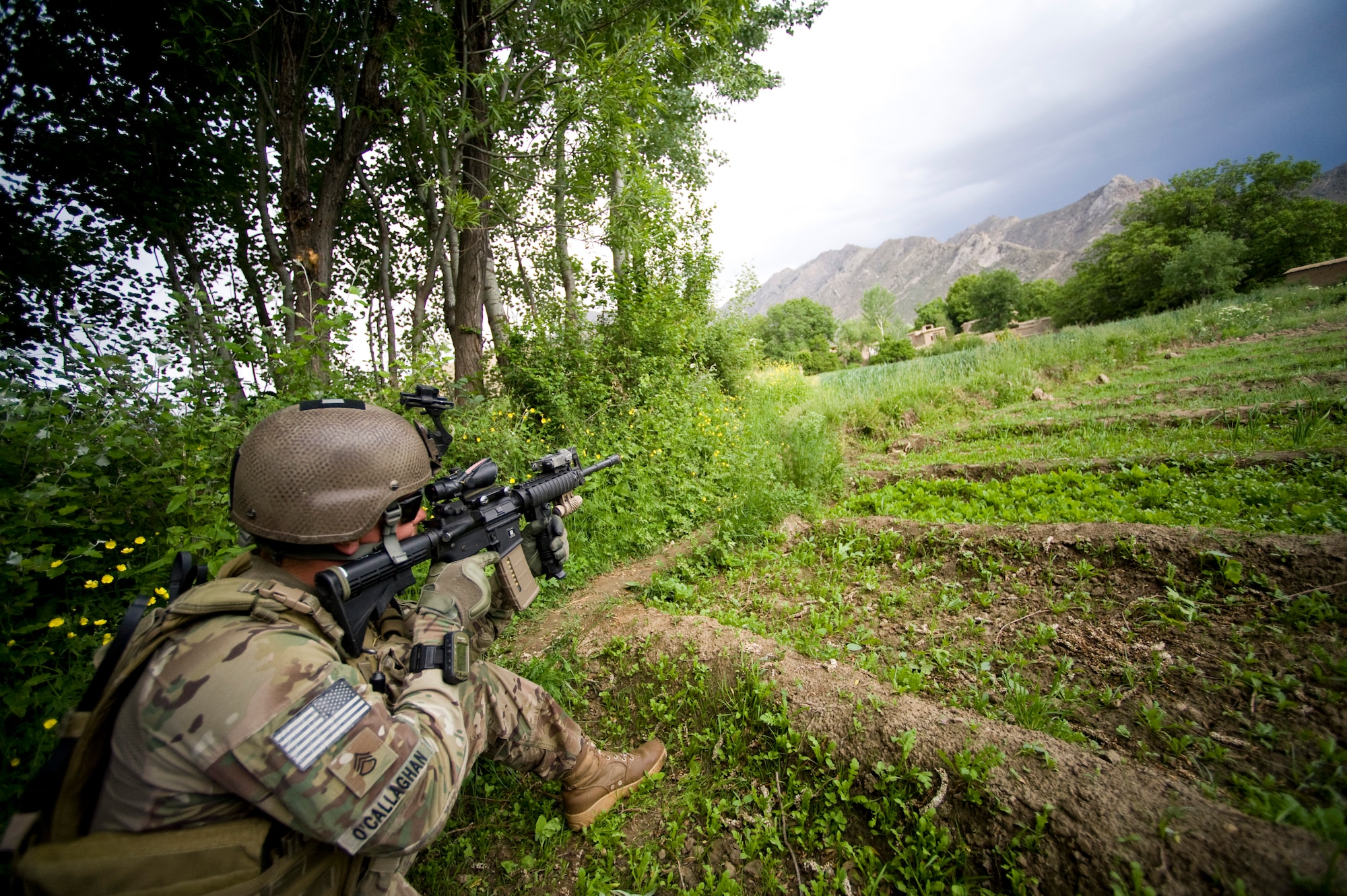 U.S. Army Staff Sgt. Christopher O'Callaghan with Provincial Reconstruction Team Kapisa's security element looks through the optic on his weapon to clear the surrounding area while an inspection is performed on a local bridge, Kapisa Province, Afghanistan, May 17, 2012. The Kapisa PRT is a U.S. military team that engages with local leaders and contractors to plan and inspect development projects in the province. (U.S. Air Force photo by Staff Sgt. Greg C. Biondo)(Released)