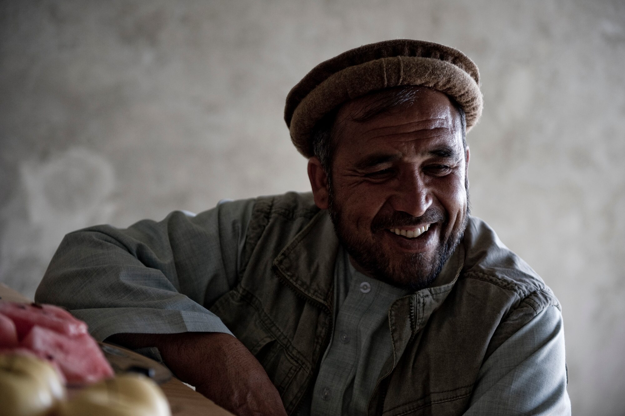 A local contractor laughs as he talks to a member of Provincial Reconstruction Team Kapisa, Kapisa Province, May 17, 2012. The Kapisa PRT is a U.S. military team that engages with local leaders and contractors to plan and inspect development projects in the province. (U.S. Air Force photo by Staff Sgt. Greg C. Biondo)(Released)