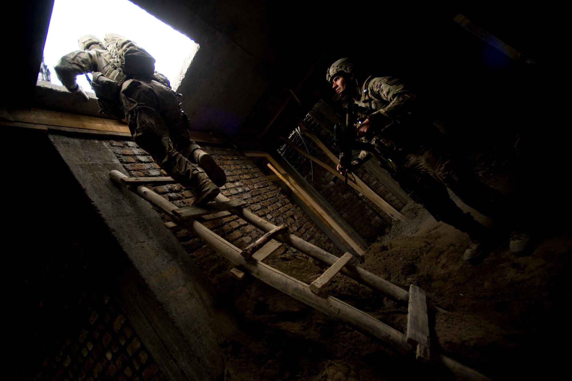 U.S. Air Force Lt. Col. Eric Shafa with Provincial Reconstruction Team Kapisa watches as a member of his team climbs up a make-shift ladder onto the roof of a school, Kapisa Province, Afghanistan, May 17, 2012. The Kapisa PRT is a U.S. military team that engages with local leaders and contractors to plan and inspect development projects in the province. (U.S. Air Force photo by Staff Sgt. Greg C. Biondo)(Released)