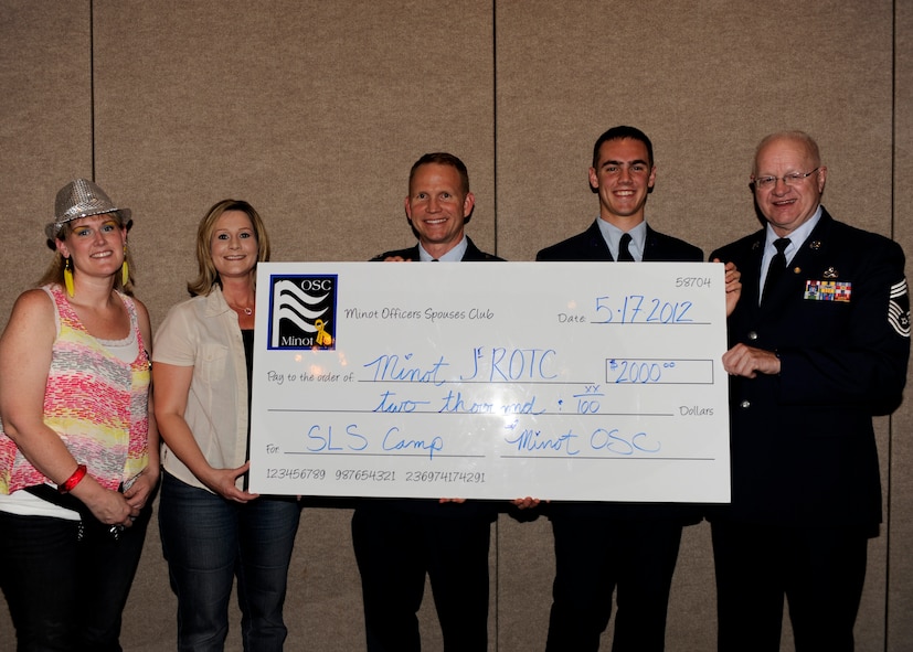 MINOT AIR FORCE BASE, N.D. -- The Minot Air Force Base’s Officers’ Spouses’ Club recently presented a $2,000 check here to the local Minot High School Air Force Junior Reserve Officers' Training Corps. The money will help fund the JROTC’s summer trip to a five day summer leadership program at Camp Grafton, N.D. (U.S. Air Force photo/Airman 1st Class Stephanie Ashley)

